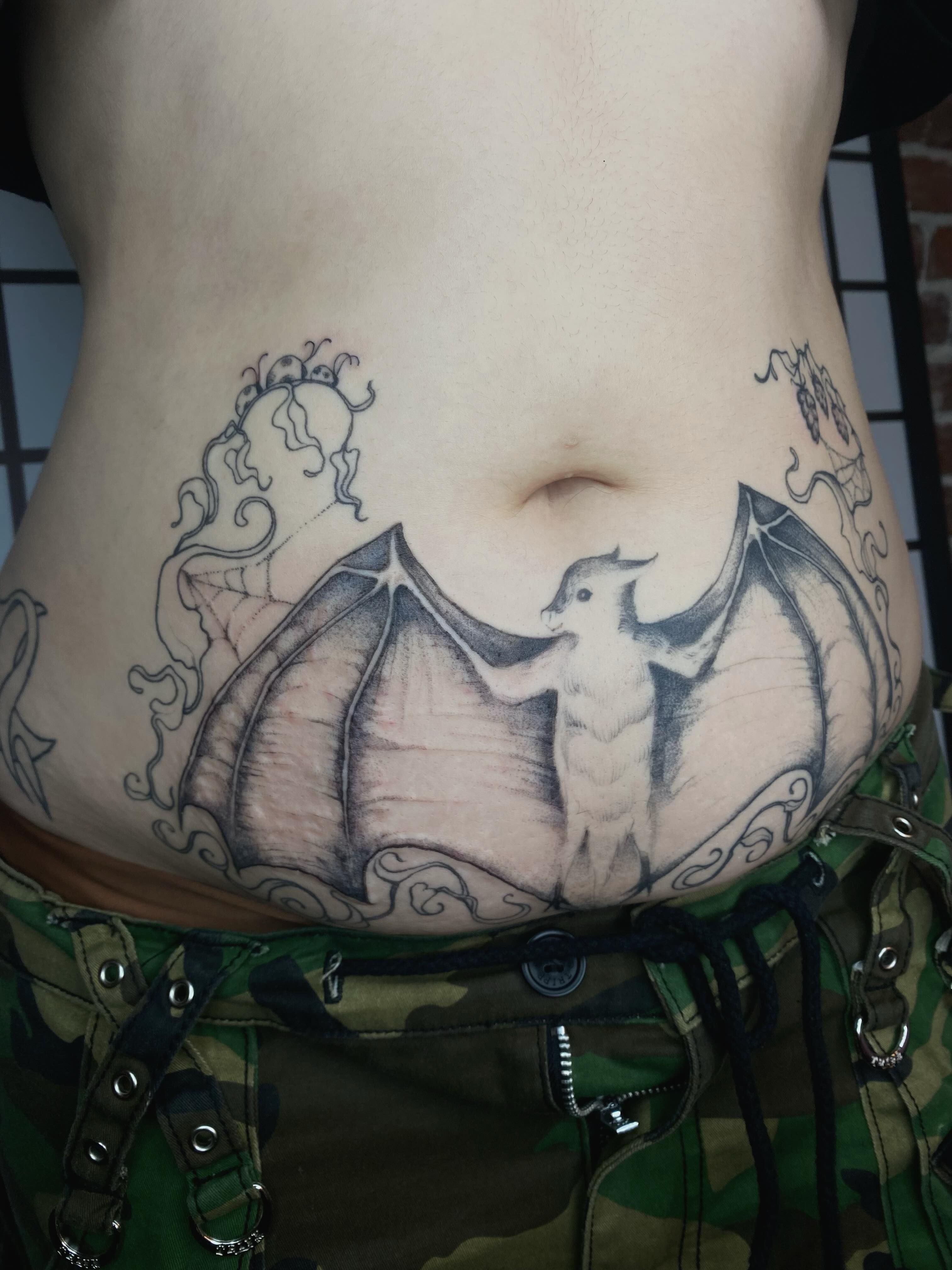 Bat black and grey tattoo on the torso by sarah 🗝️