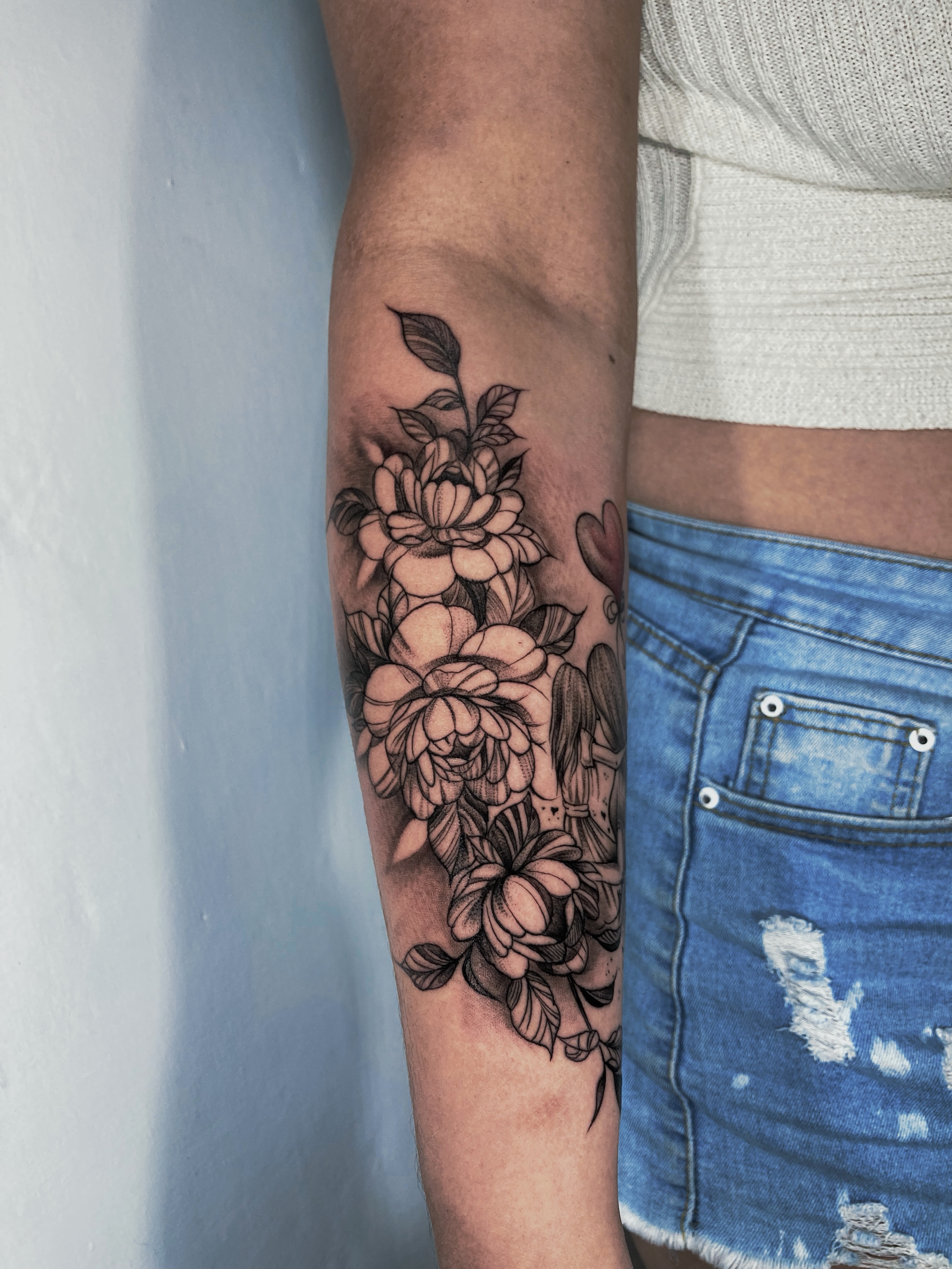Floral arrangement fine line tattoo on the forearm by Alvaro