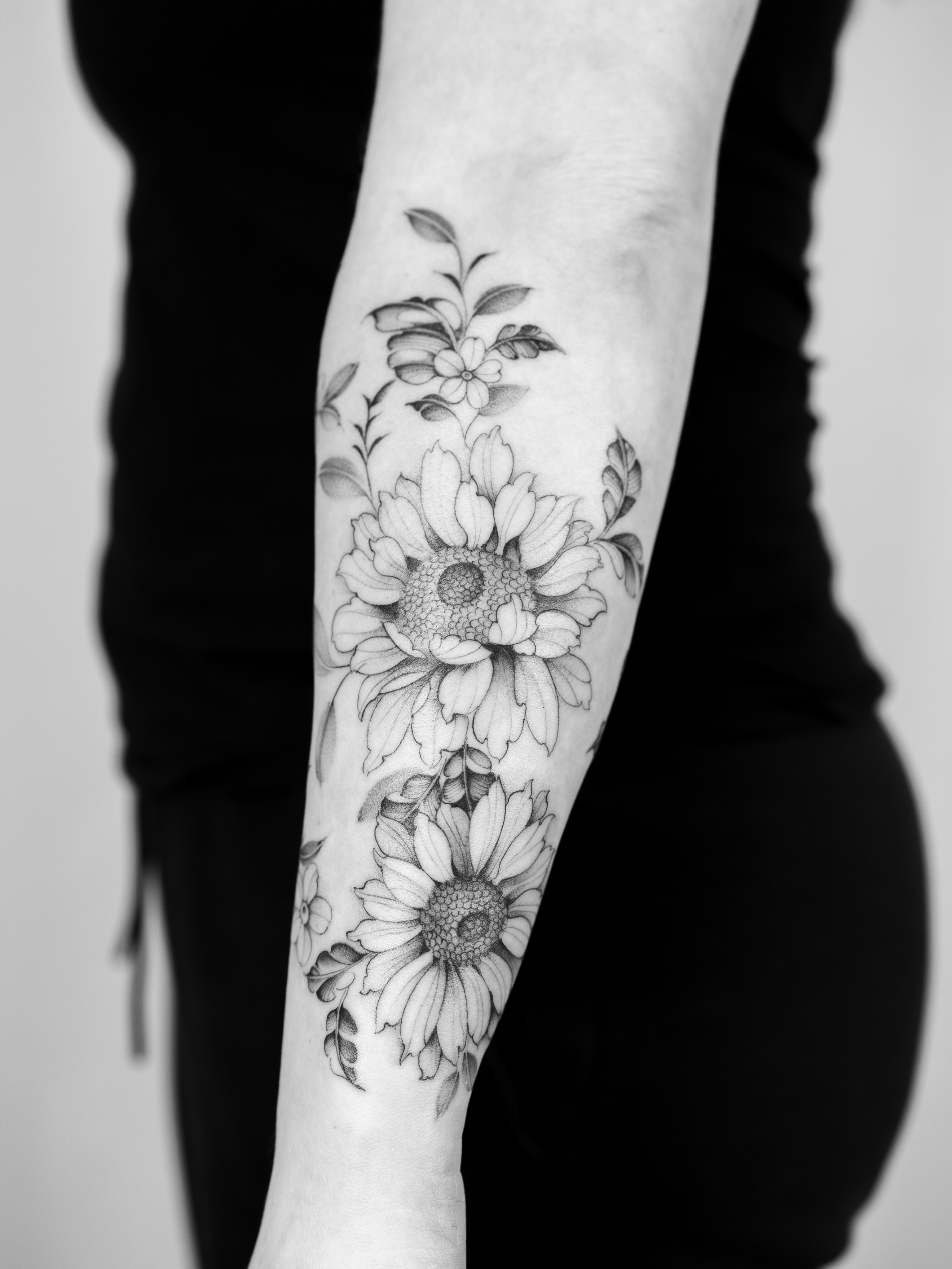 Sunflowers black and grey tattoo on the forearm by Leo Gao