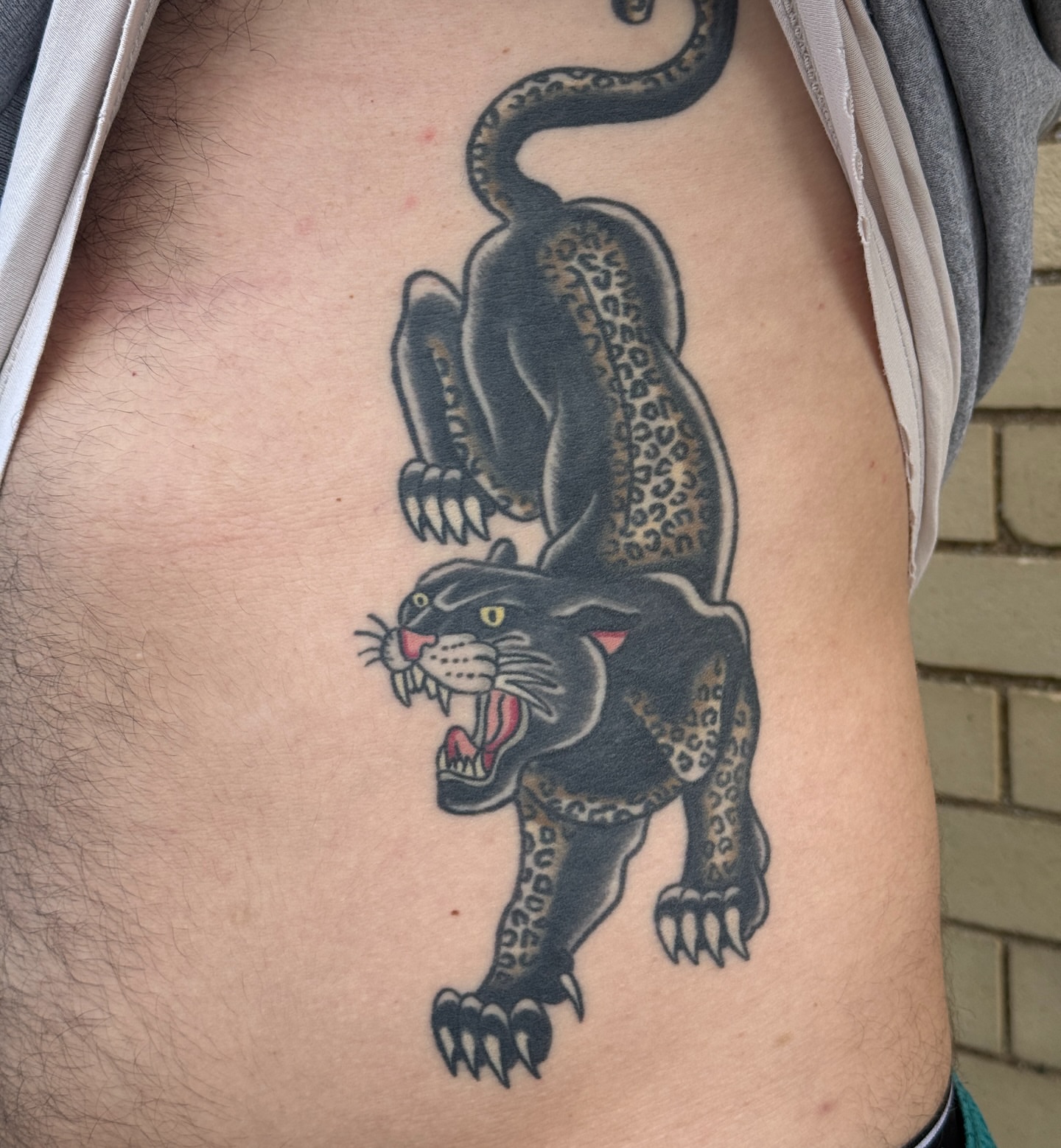 Panther American traditional tattoo on the ribs by Mo