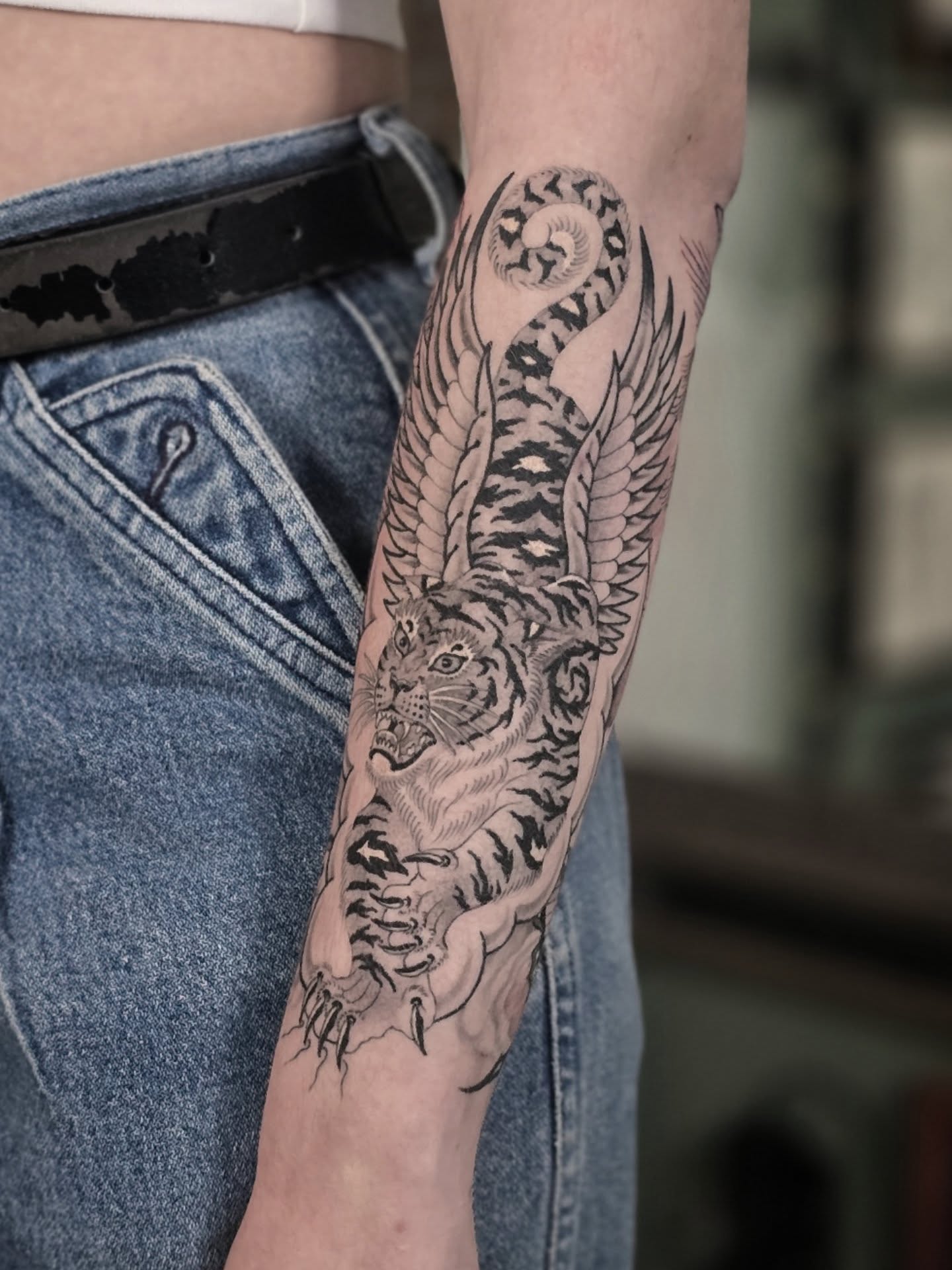 Tiger black and grey tattoo on the forearm by Aaron Dor