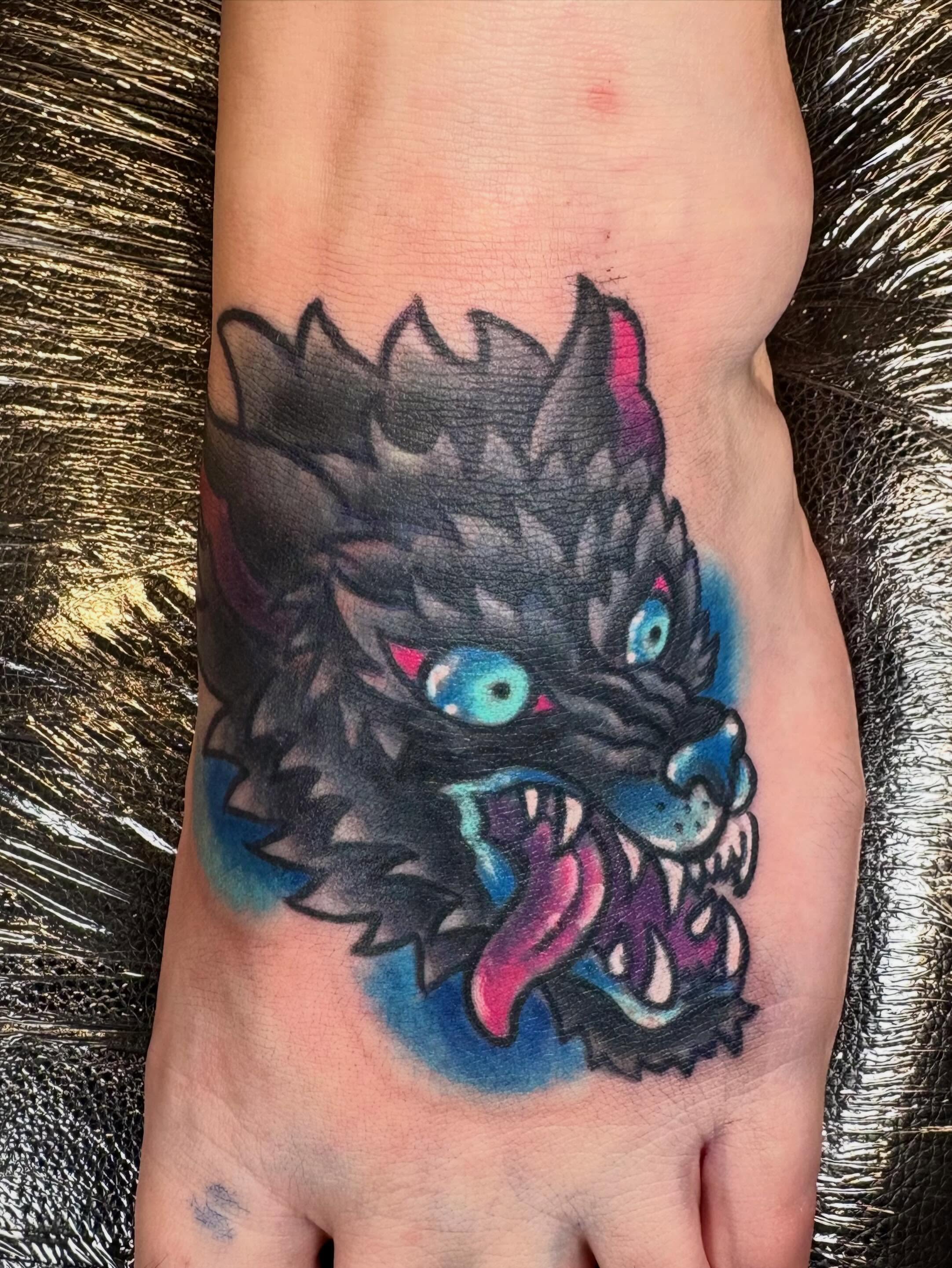 Wolf head American traditional tattoo on the foot by Bre Alex