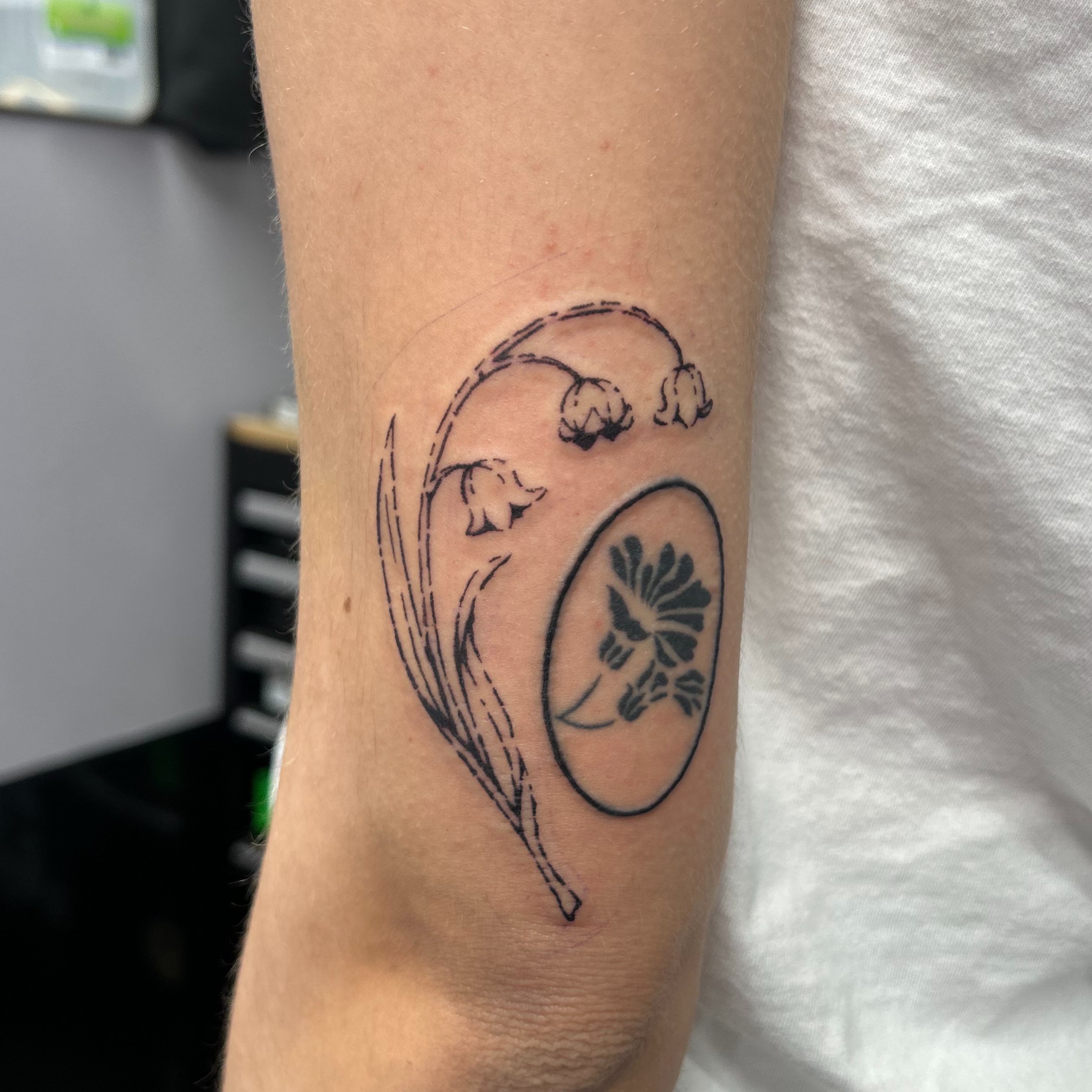 Flower and leaf black and grey tattoo on the forearm by Natalie Johnson, Minneapolis, Minnesota