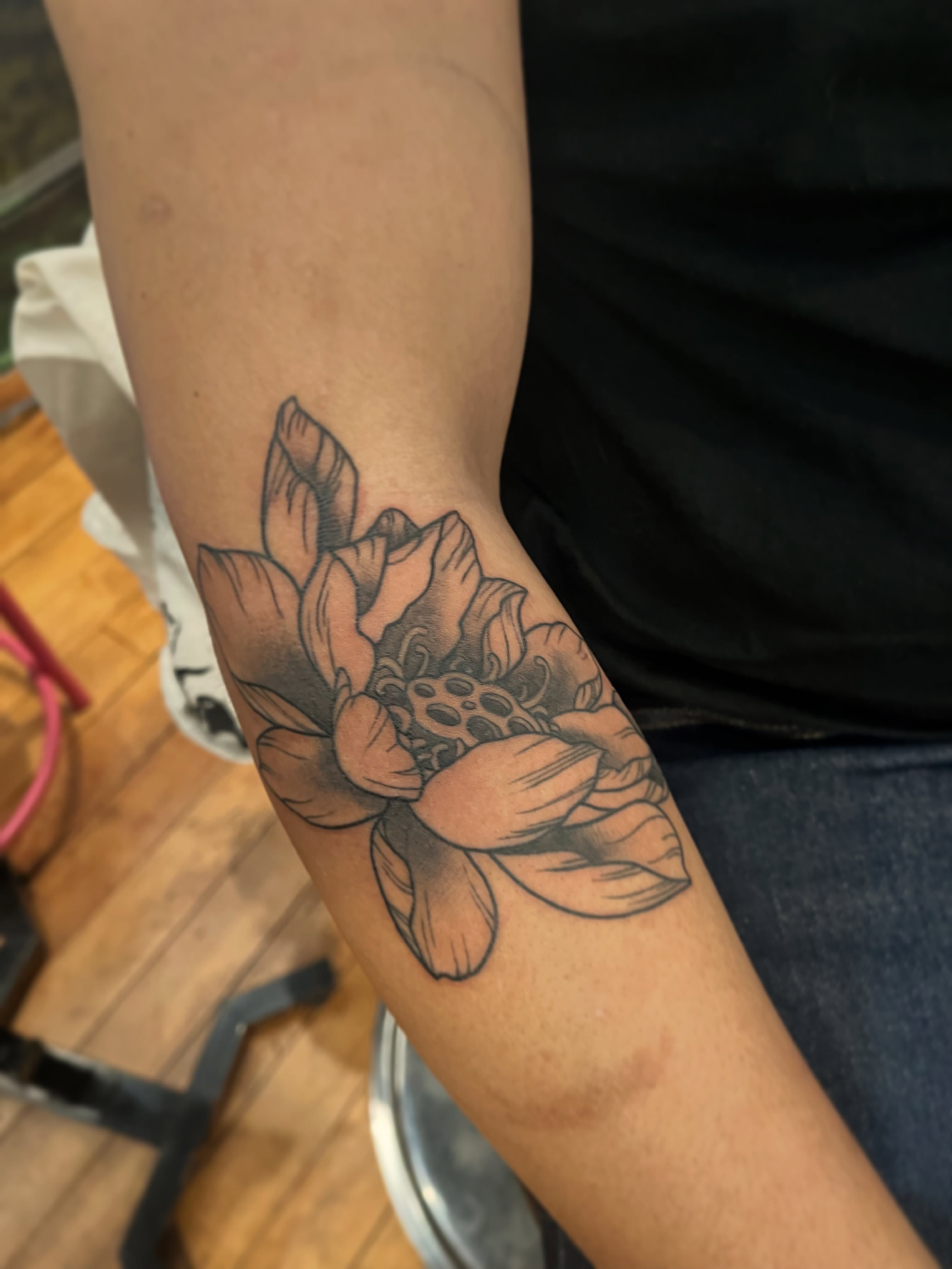 Lotus flower black and grey tattoo on the forearm by Zoe Phan, Richmond, Virginia