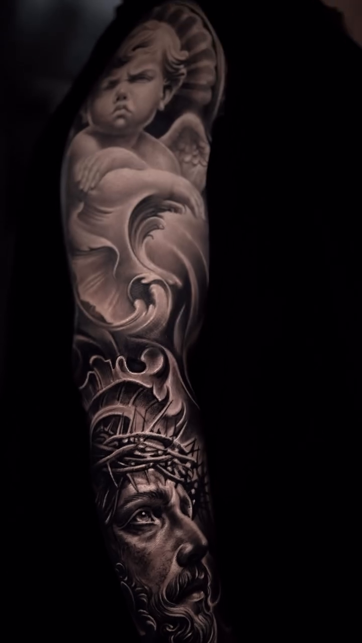 Jesus Christ and cherub sleeve realism tattoo on the forearm by π¨π»βπ¨Ever luis Rivero π¨π»βπ¨