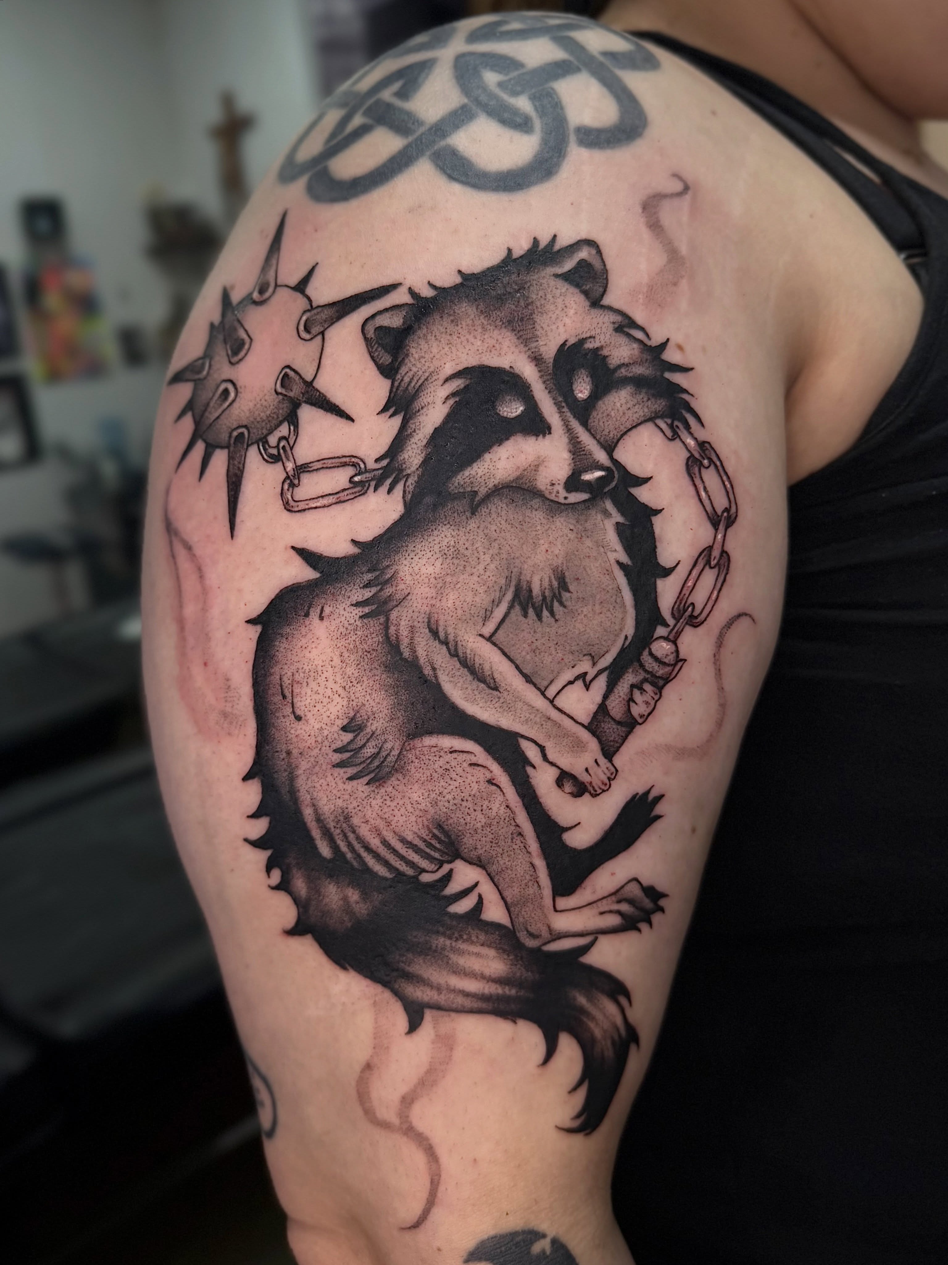 Raccoon black and grey tattoo on the shoulder by Halle Cooper