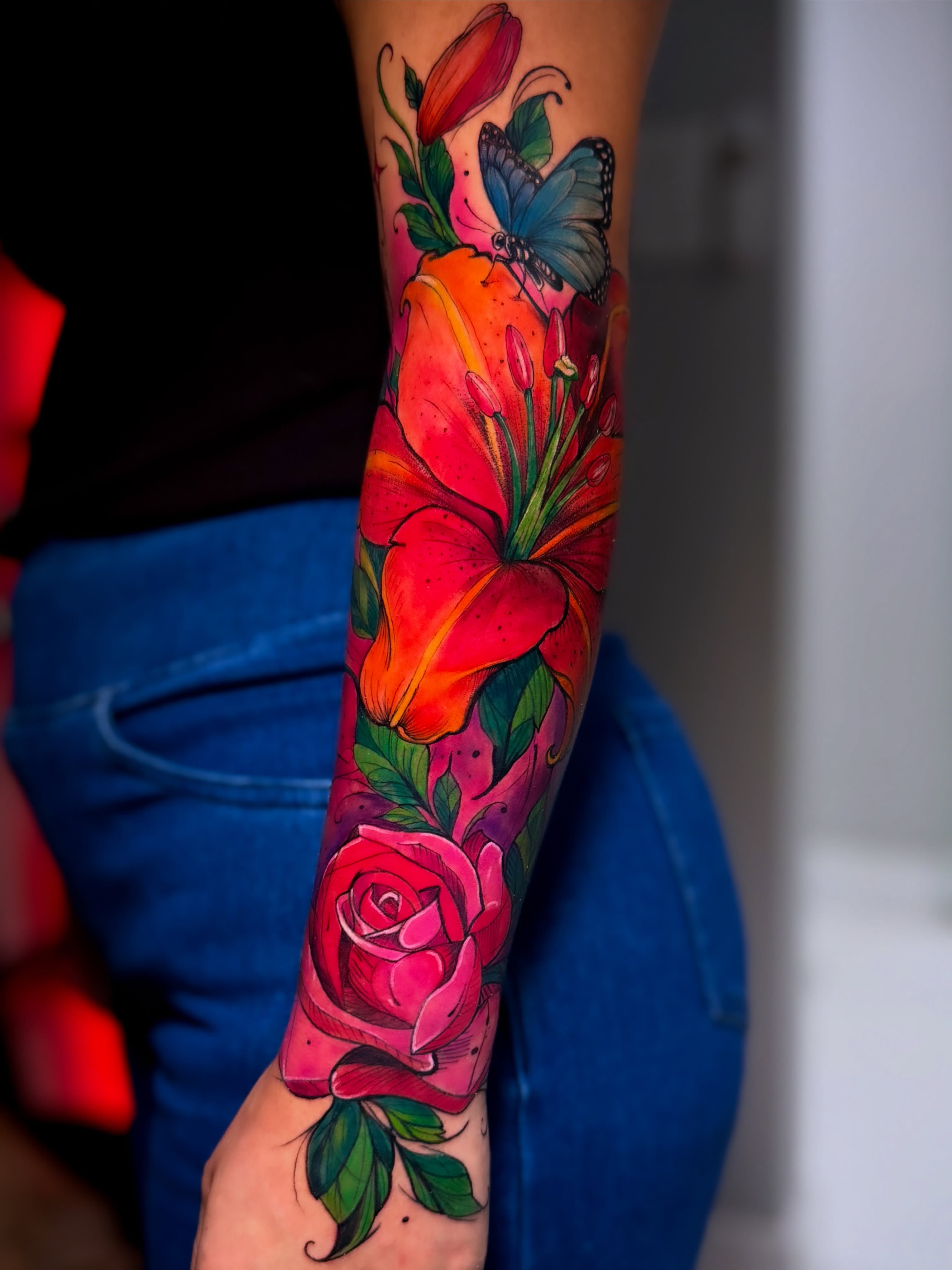 Flowers and butterfly watercolor tattoo on the forearm by Eyinay Cabezas 🇨🇺🇺🇸
