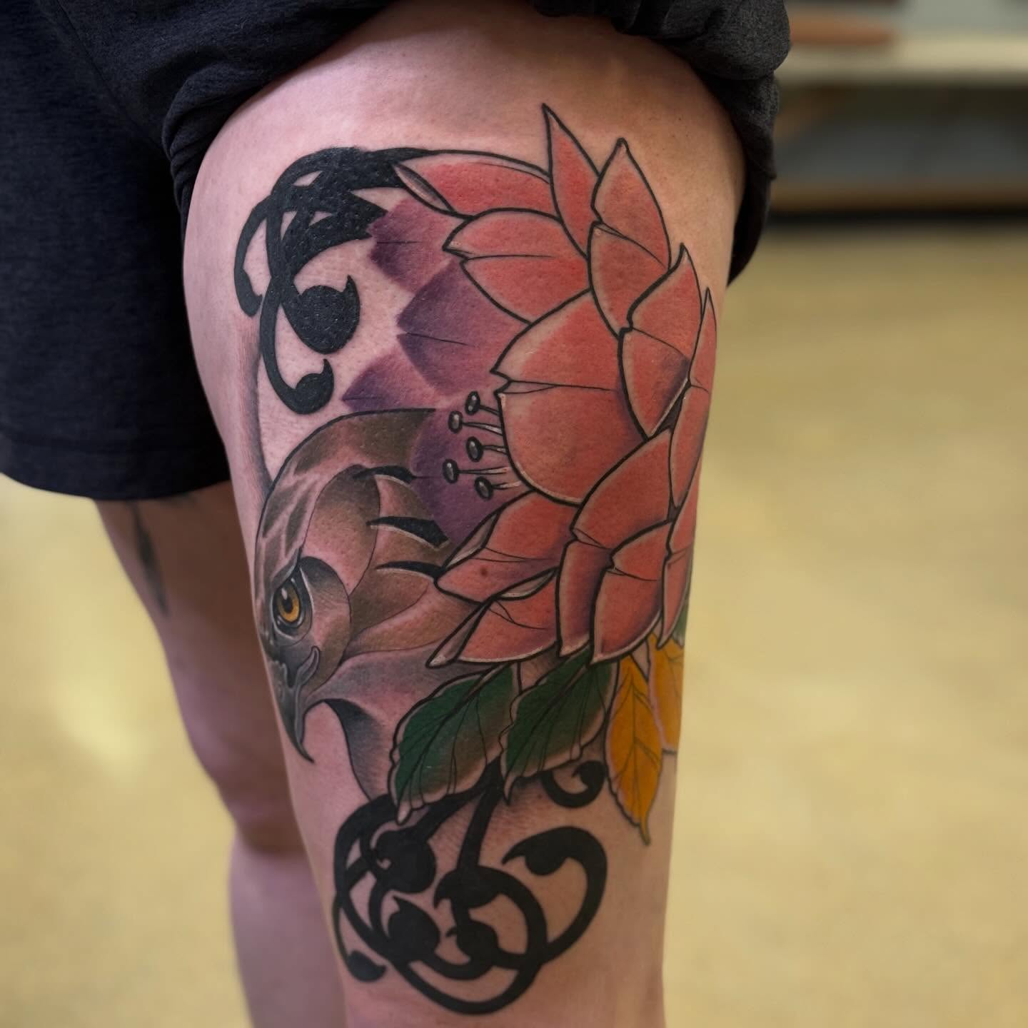 Bird and flower realism tattoo on the thigh by Chris Smiseck