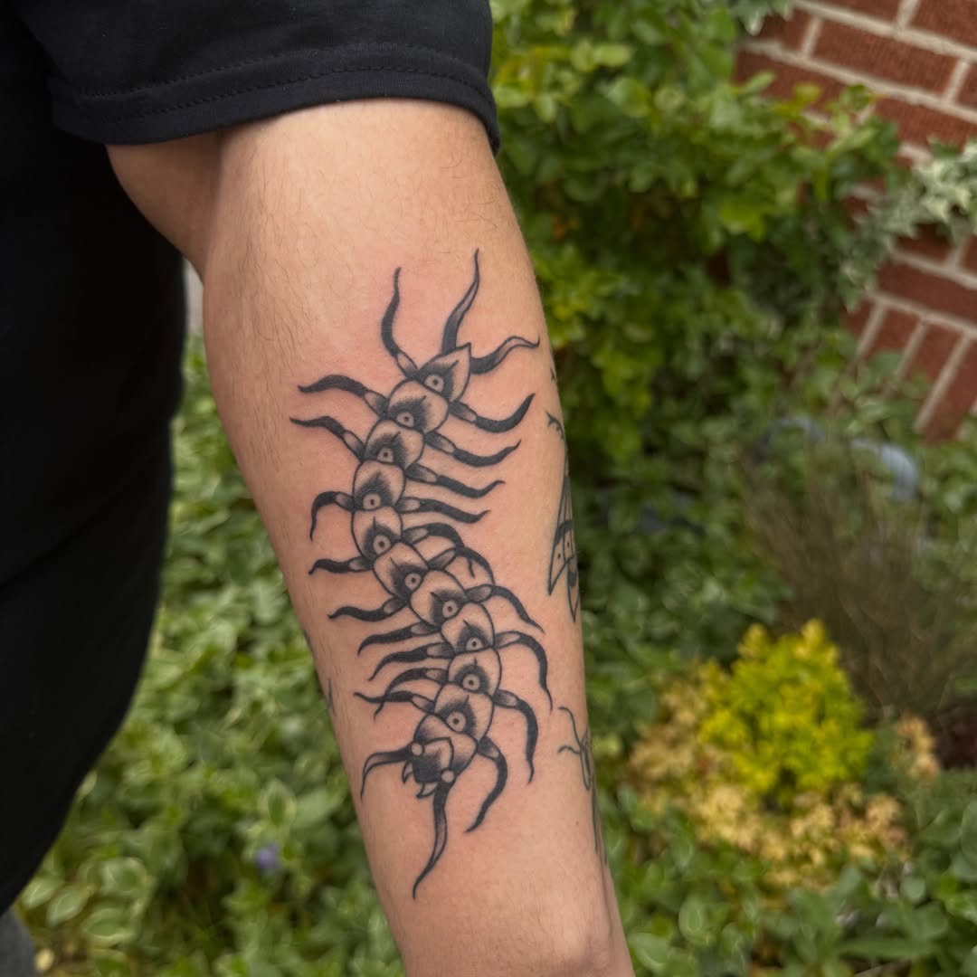 Centipede black and grey tattoo on the forearm by Kaysen