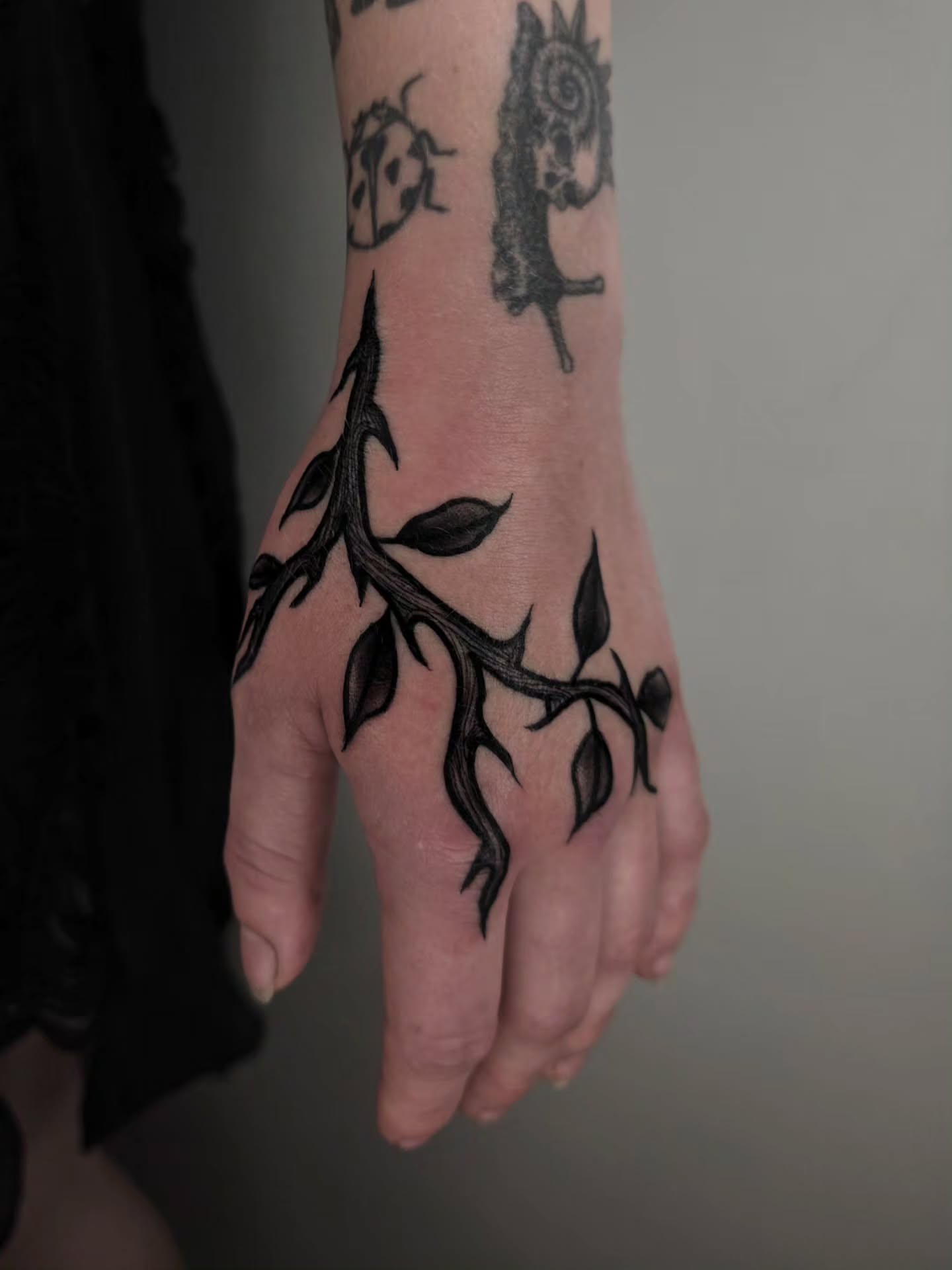 Thorn branch black and grey tattoo on the hand by ☻ Addie