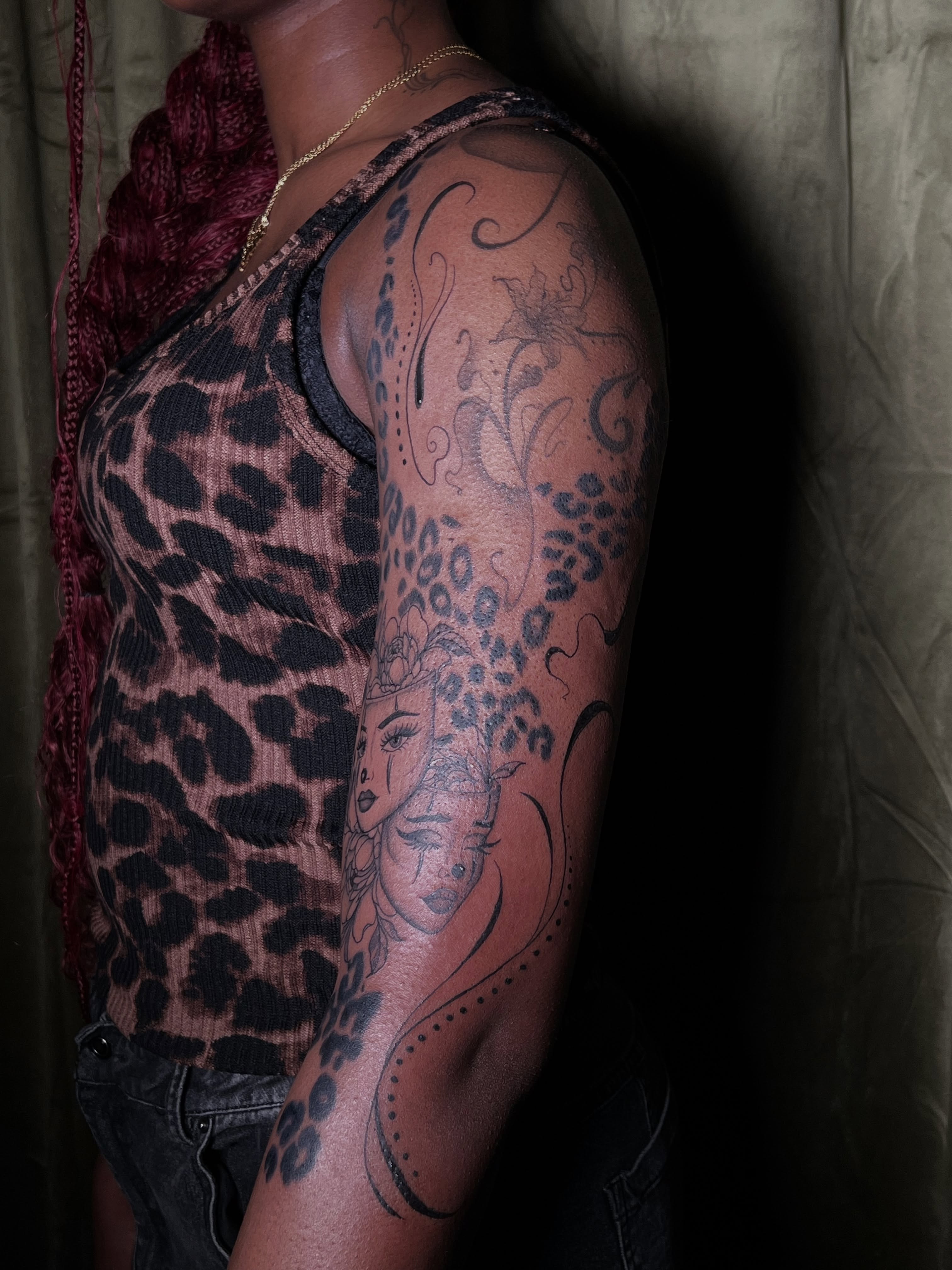 Woman's face dotwork tattoo on the upper arm by V
