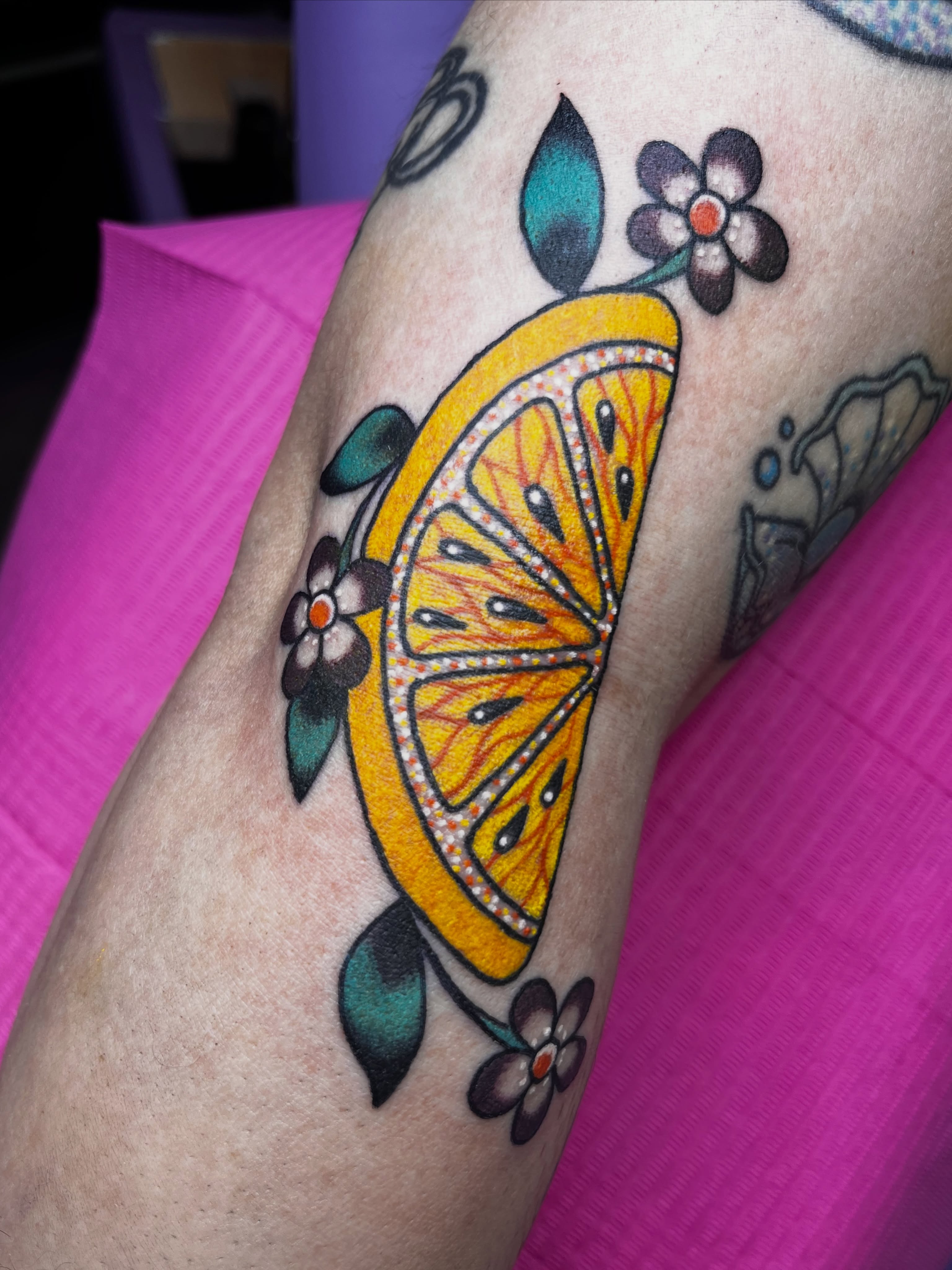 Slice of lemon American traditional tattoo on the forearm by Cincinnati Tattoo Artist, Cincinnati