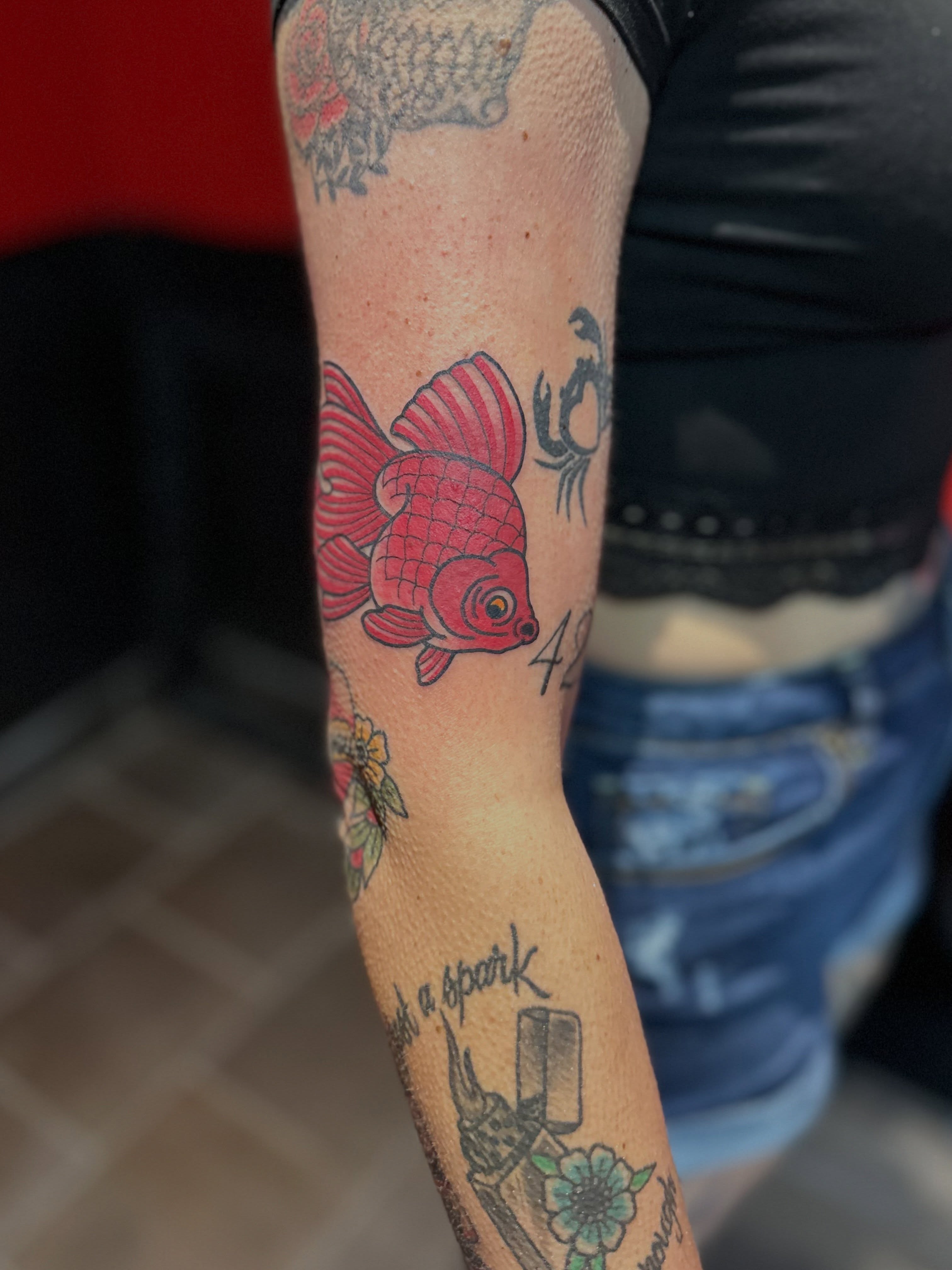 Goldfish American traditional tattoo on the forearm by Walk-in American Traditional Tattoos Las