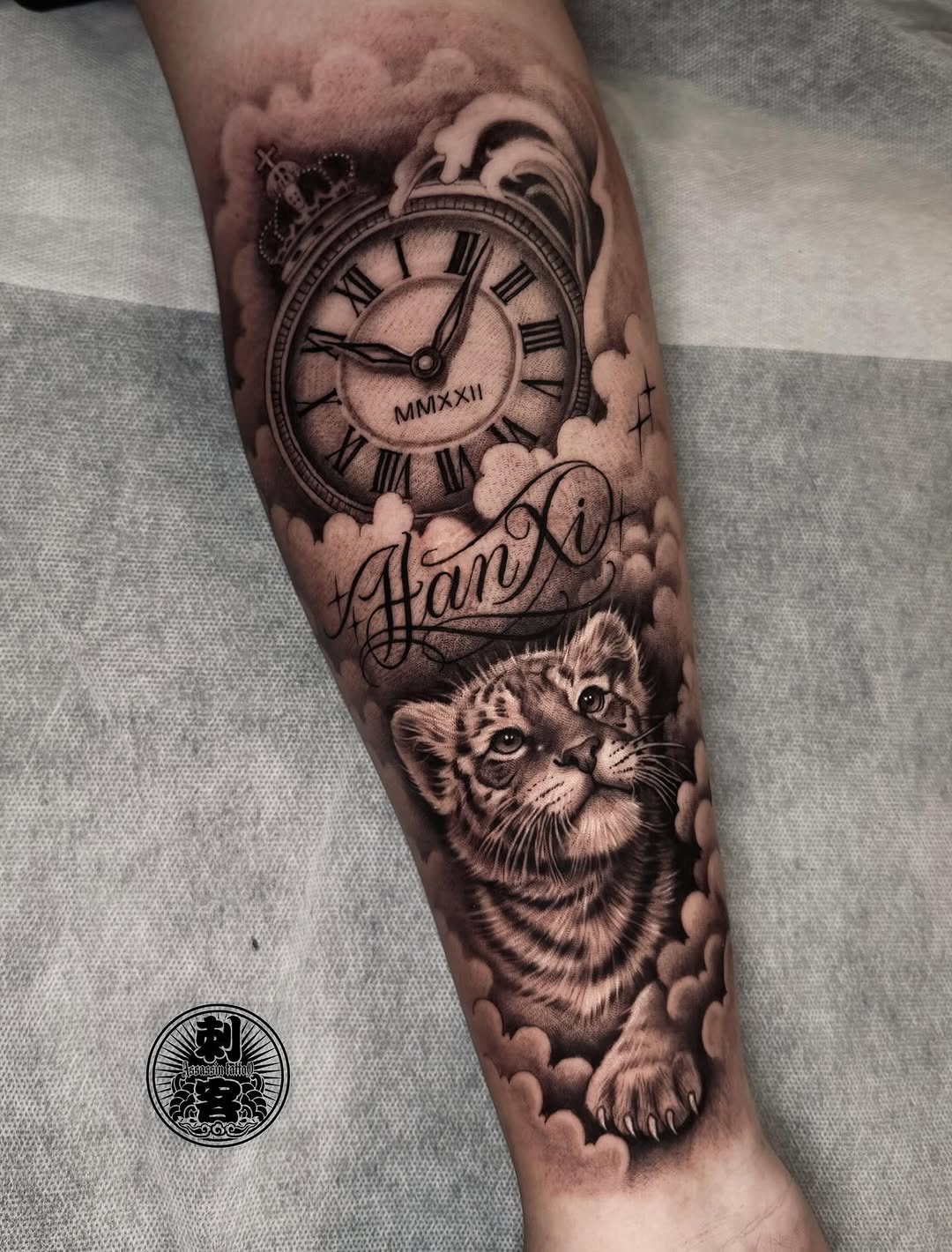 Tiger cub and pocket watch realism tattoo on the forearm by Duo