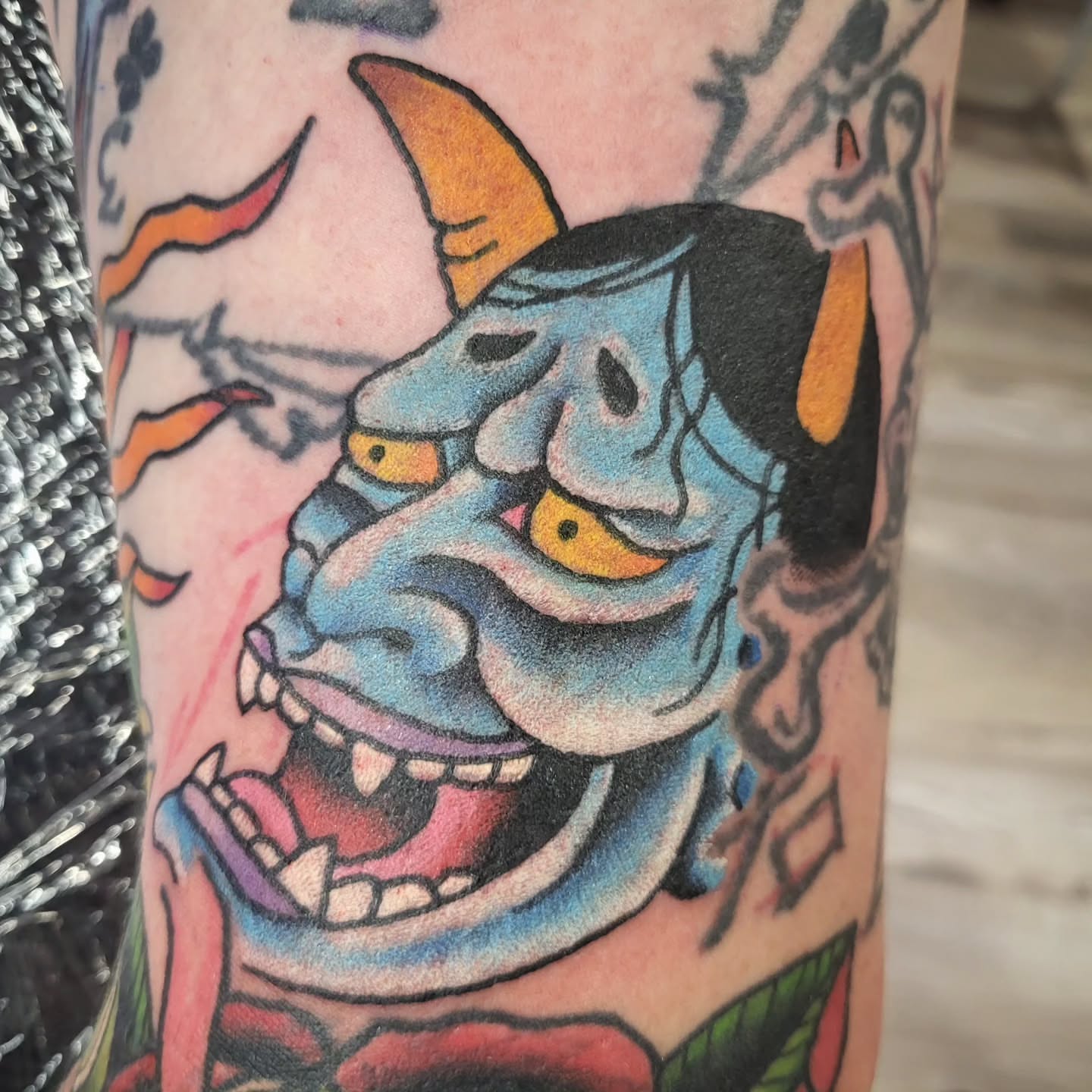 Demon mask American traditional tattoo on the forearm by Sloan Smith