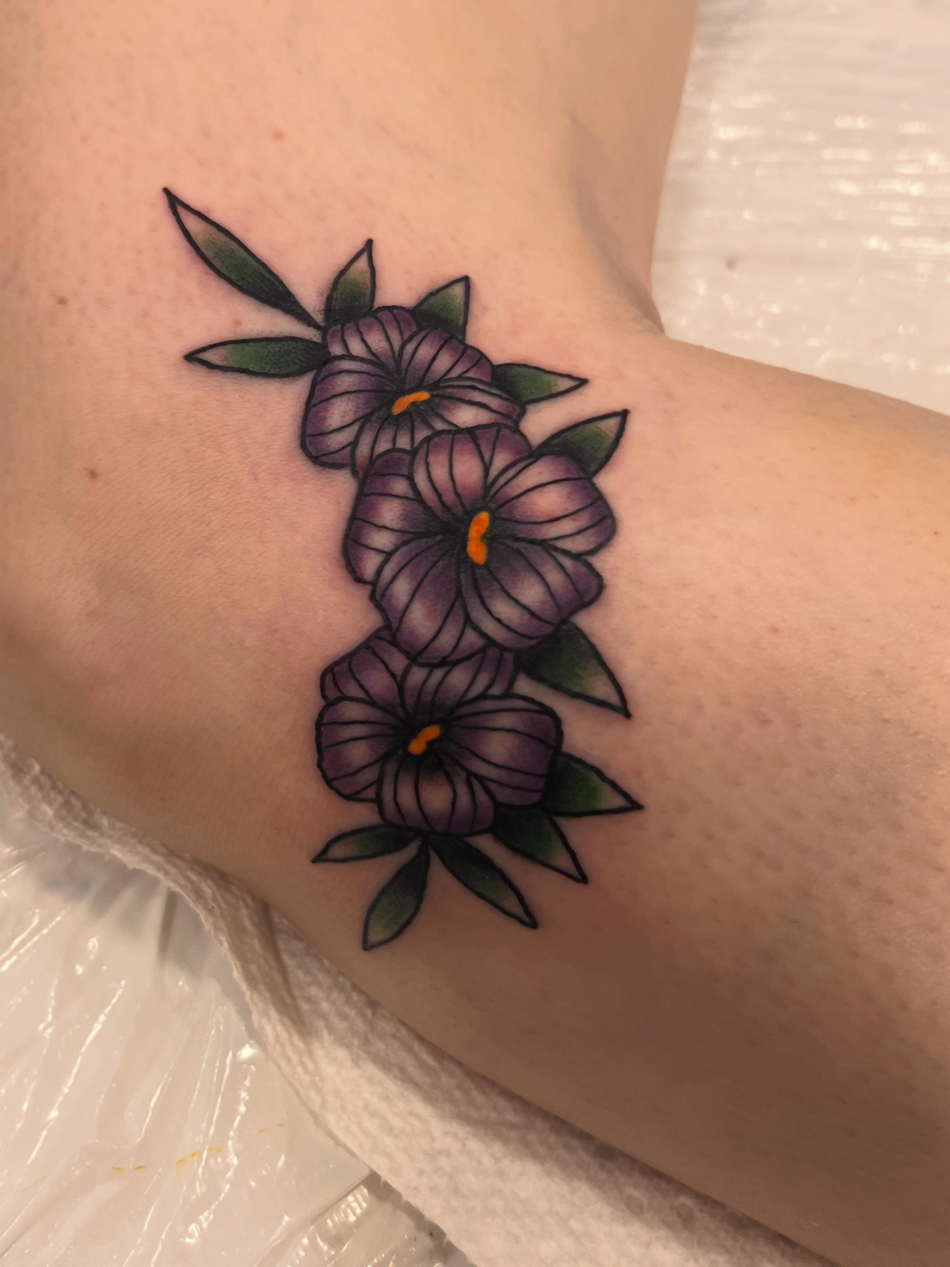 Purple flowers new school tattoo on the forearm by Samantha Citer