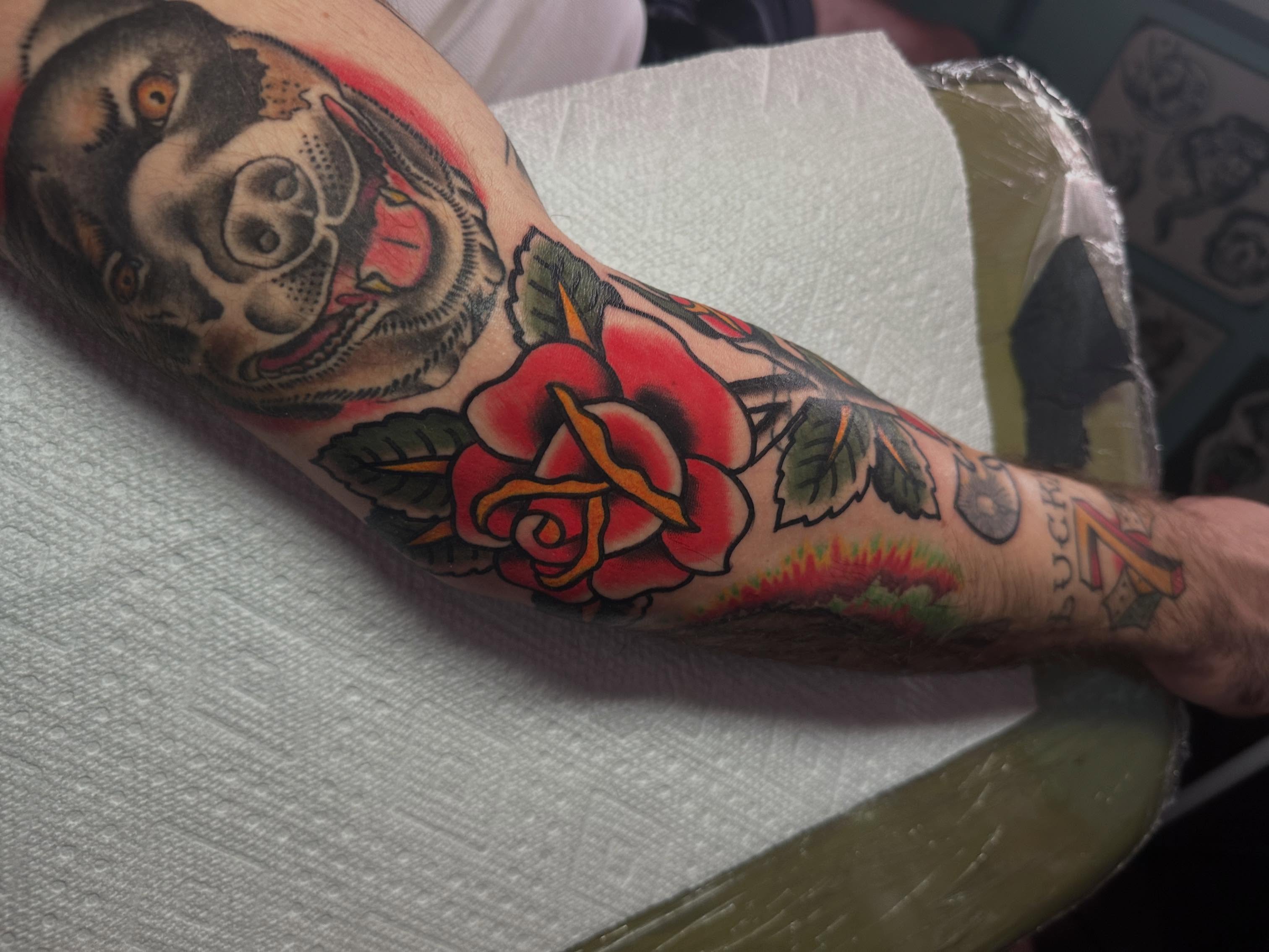 Skull and rose American traditional tattoo on the forearm by Chris Bishop