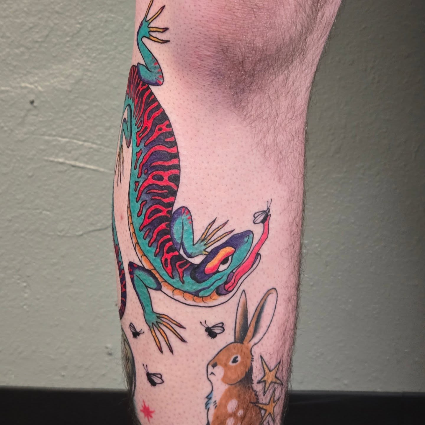 Lizard and bee American traditional tattoo on the forearm by alec