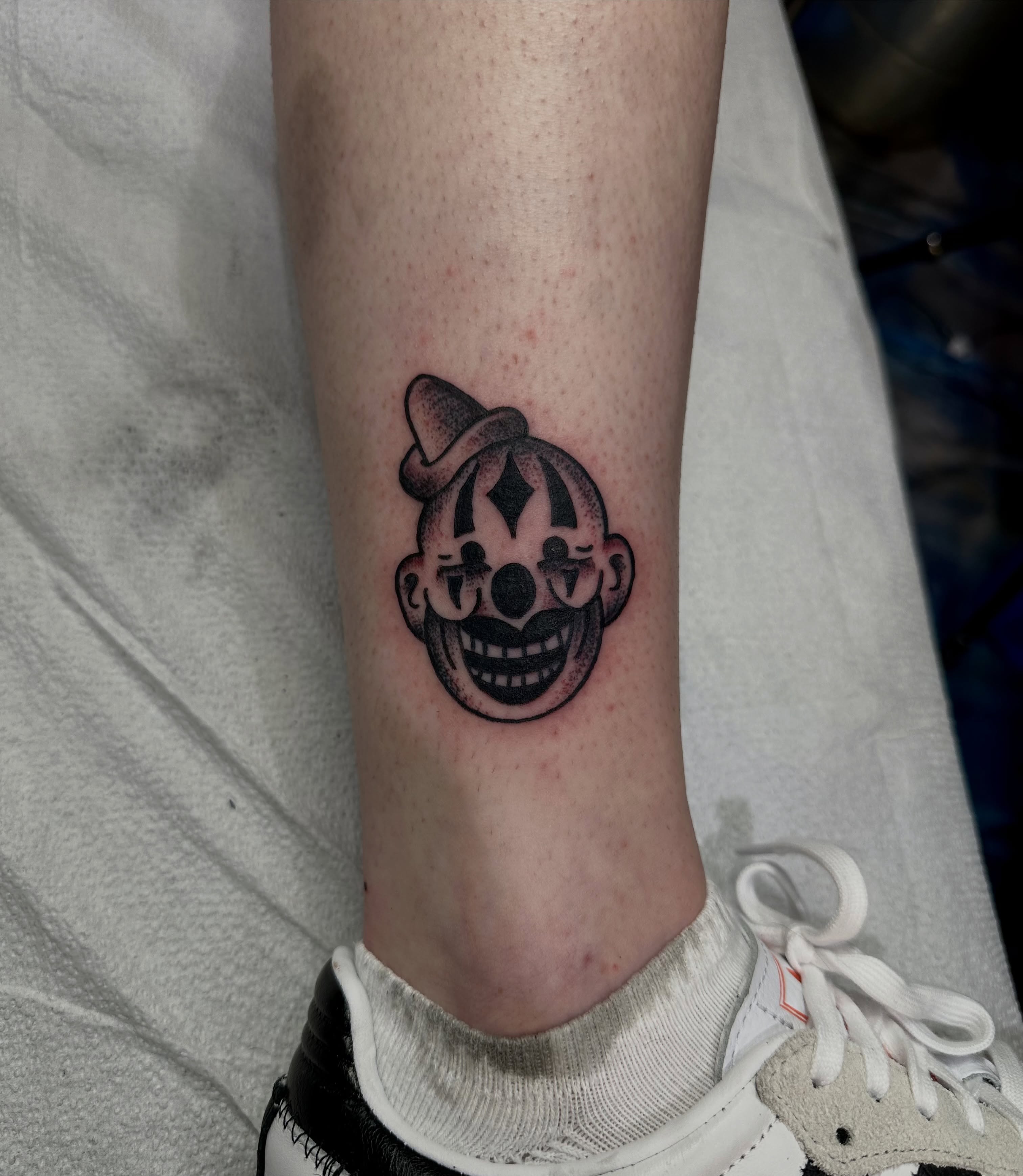Clown face dotwork tattoo on the forearm by teddy, Portland, Oregon