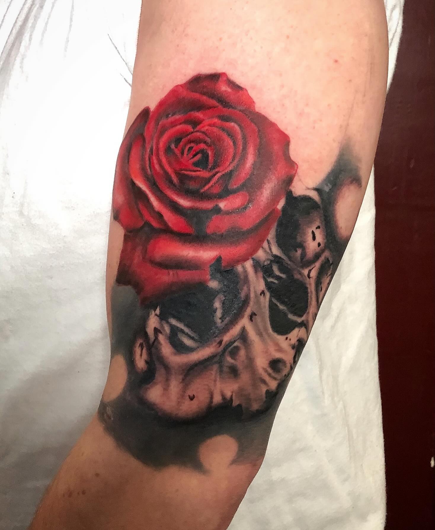 Red rose realism tattoo on the forearm by Matthew Crawley