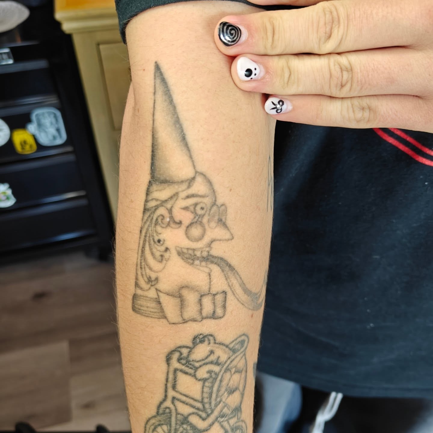 Gnome black and grey tattoo on the forearm by Meg
