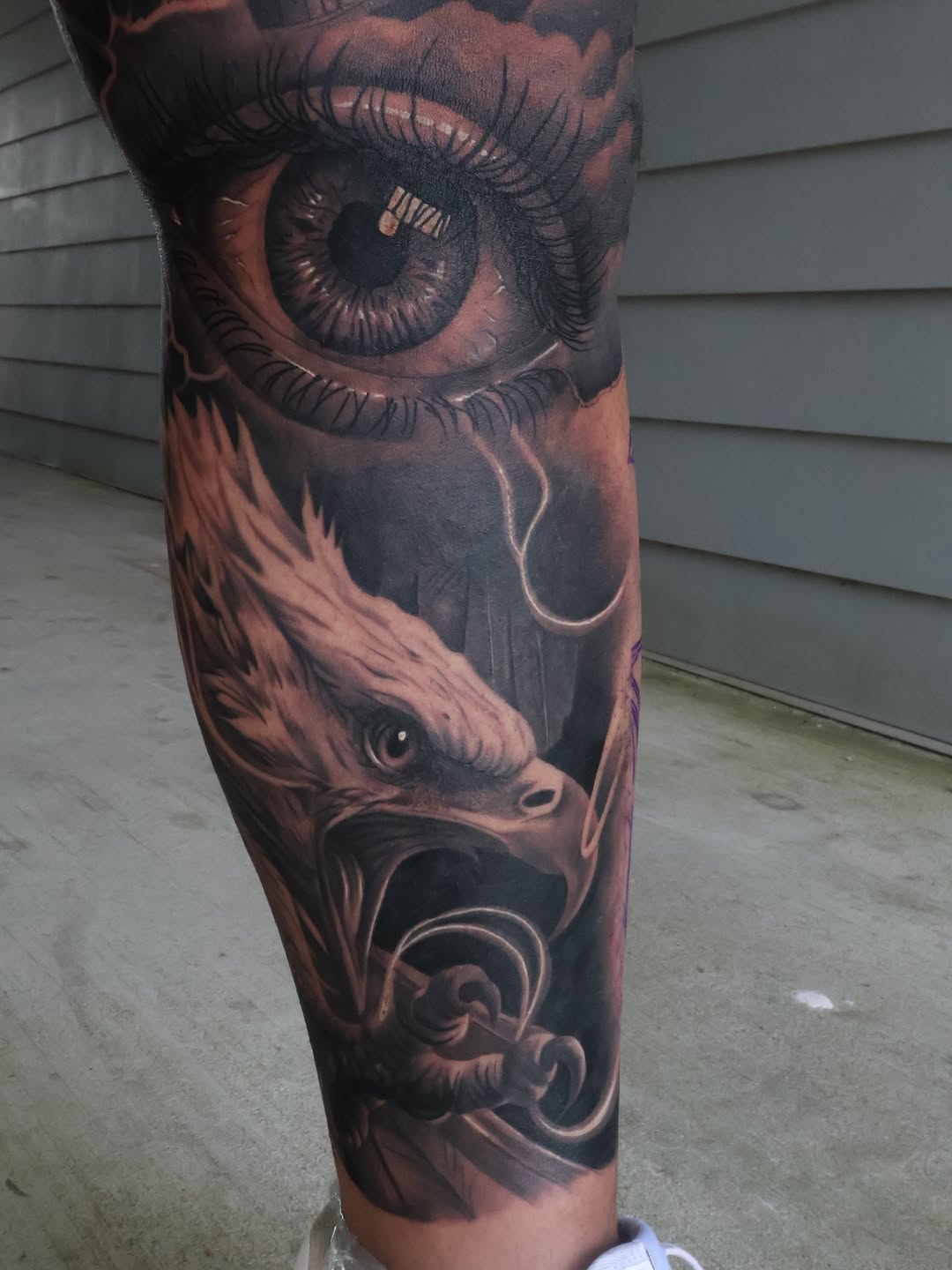 Eye and eagle surrealism tattoo on the forearm by Angels tattoo