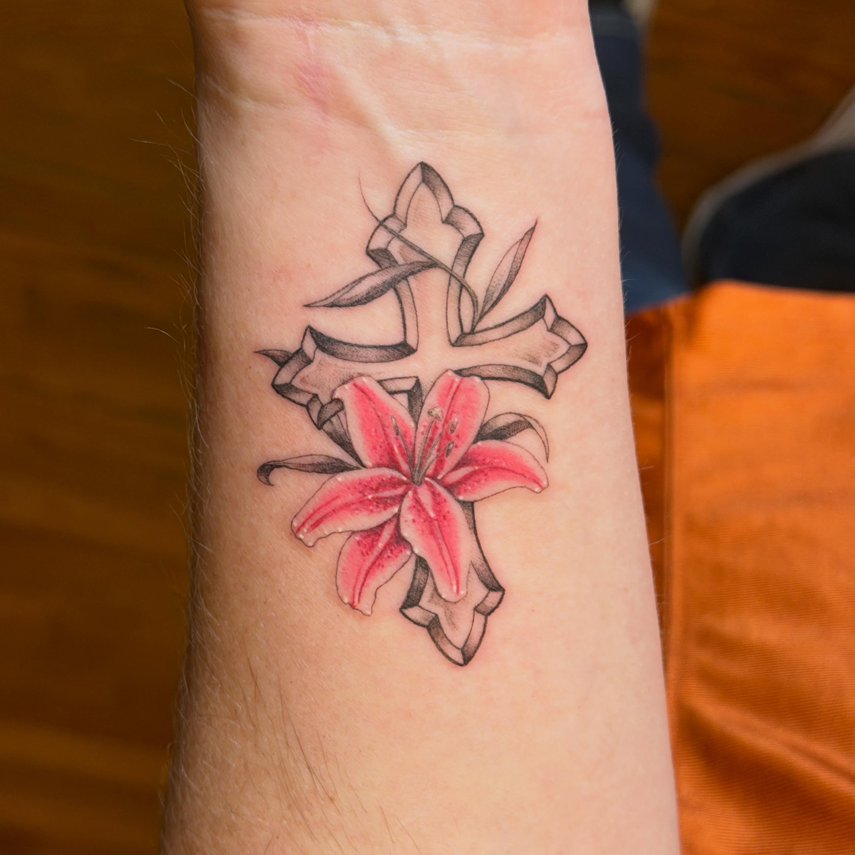 Lily and cross black and grey tattoo on the forearm by Raul Najera Tattoo, Plano, Texas