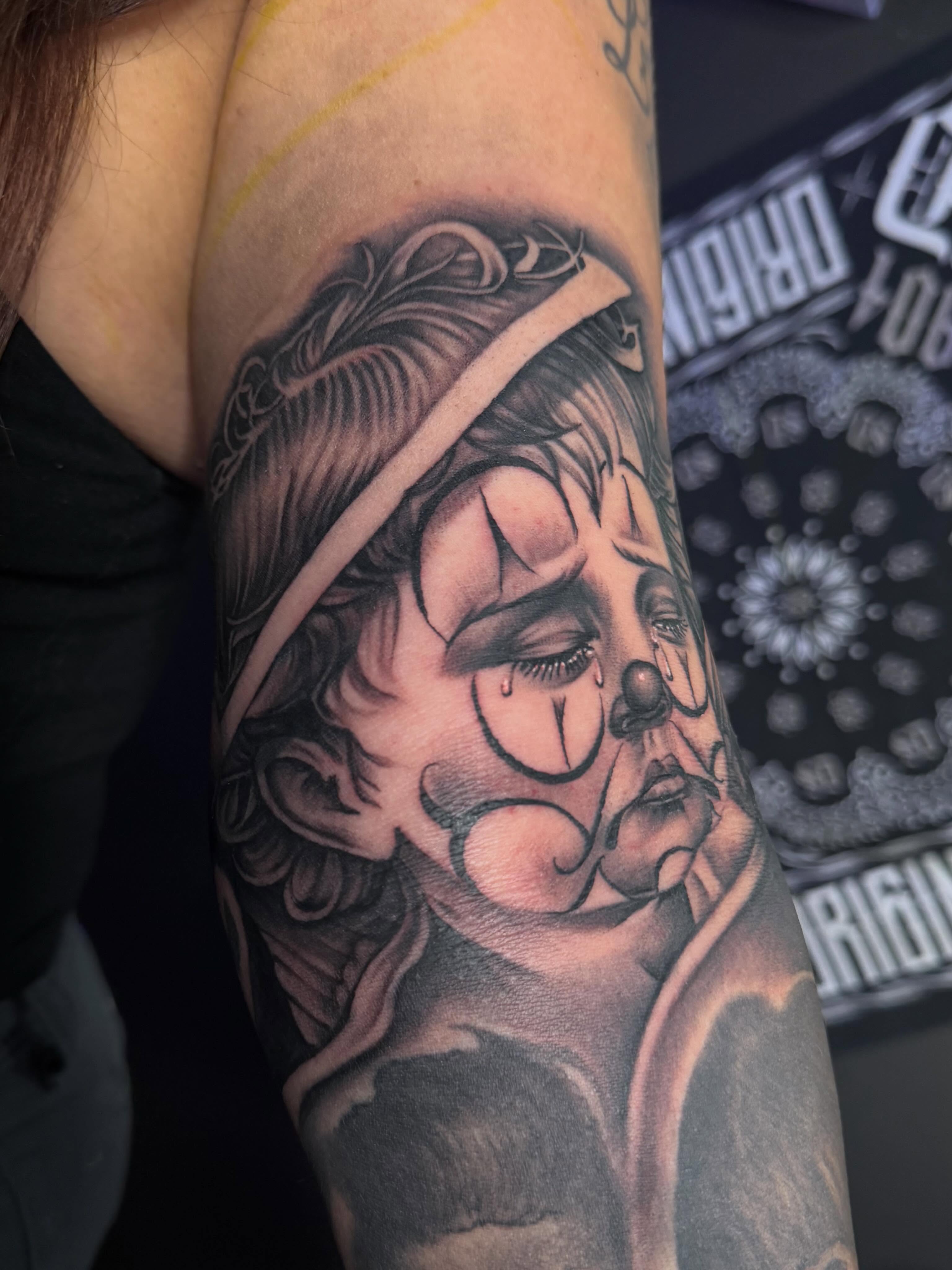 Clown black and grey tattoo on the forearm by San Diego Tattoo Artist
