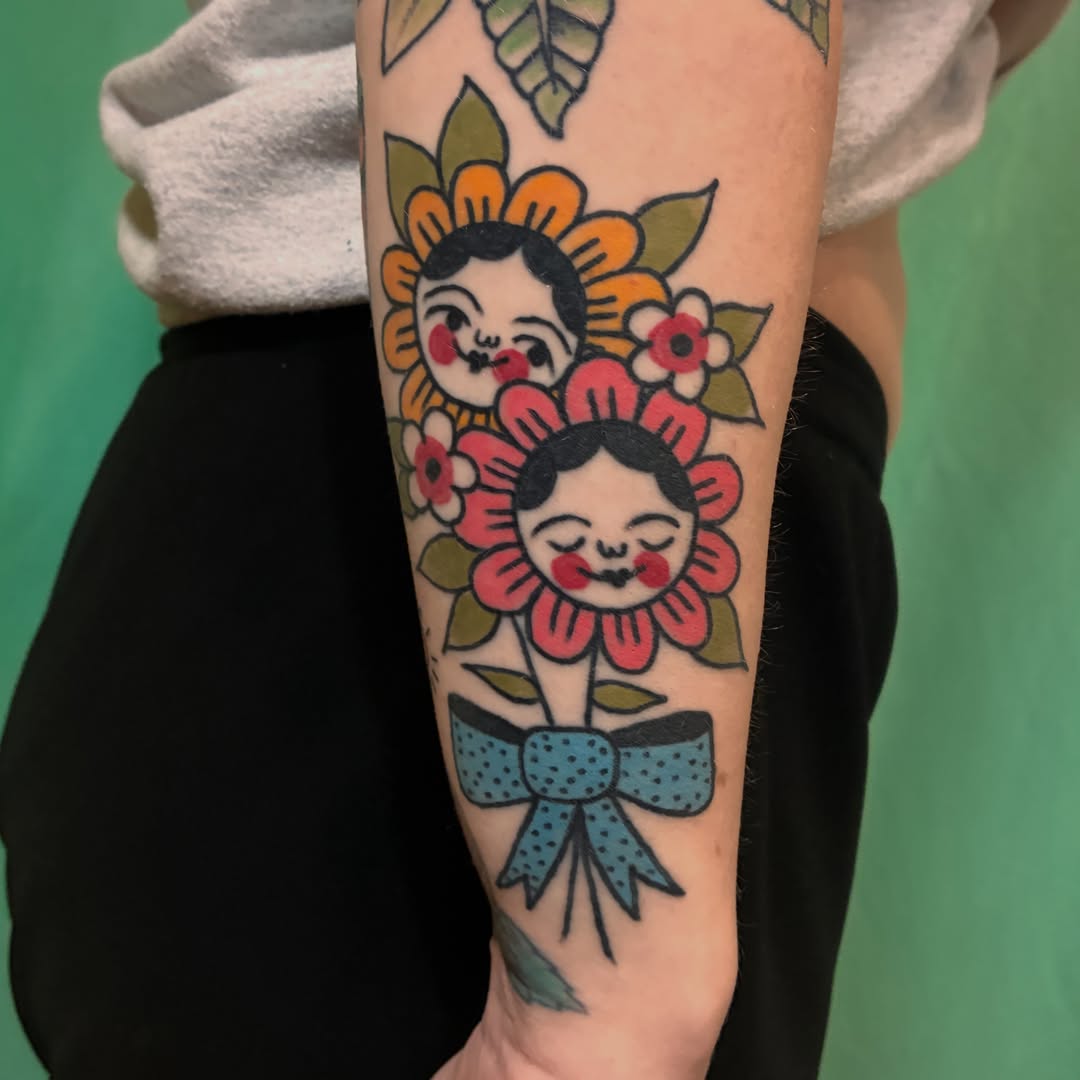 Flower dolls American traditional tattoo on the forearm by Kaily McKee
