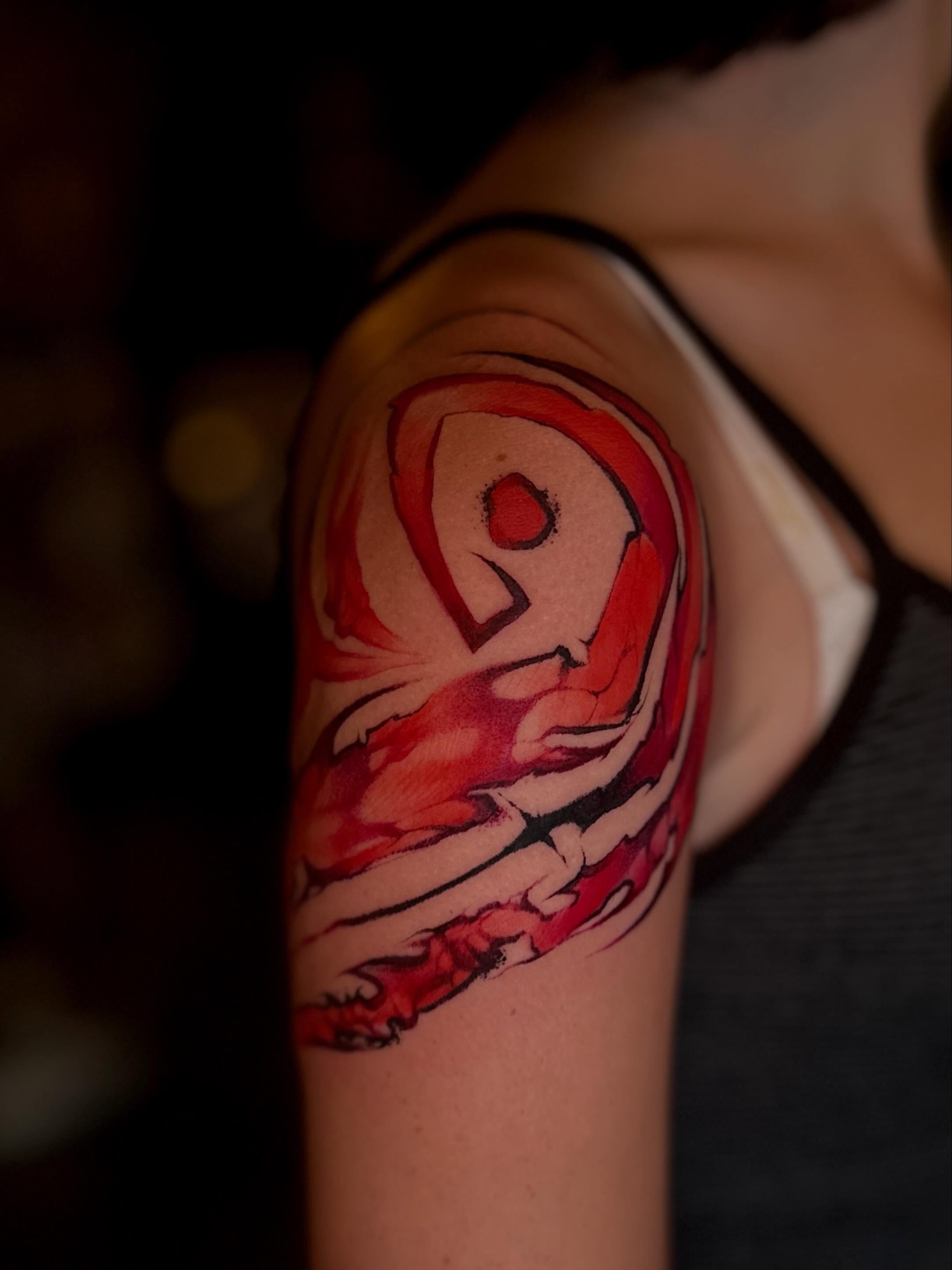 Abstract flame watercolor tattoo on the upper arm by Mattison Fire 🔥Tallahassee Tattoo Artist