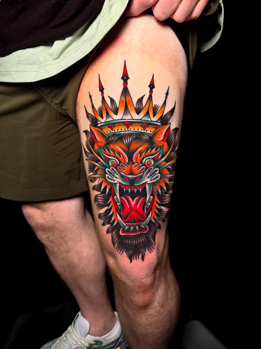 Tiger head with crown neo-traditional tattoo on the thigh by Nate Masi