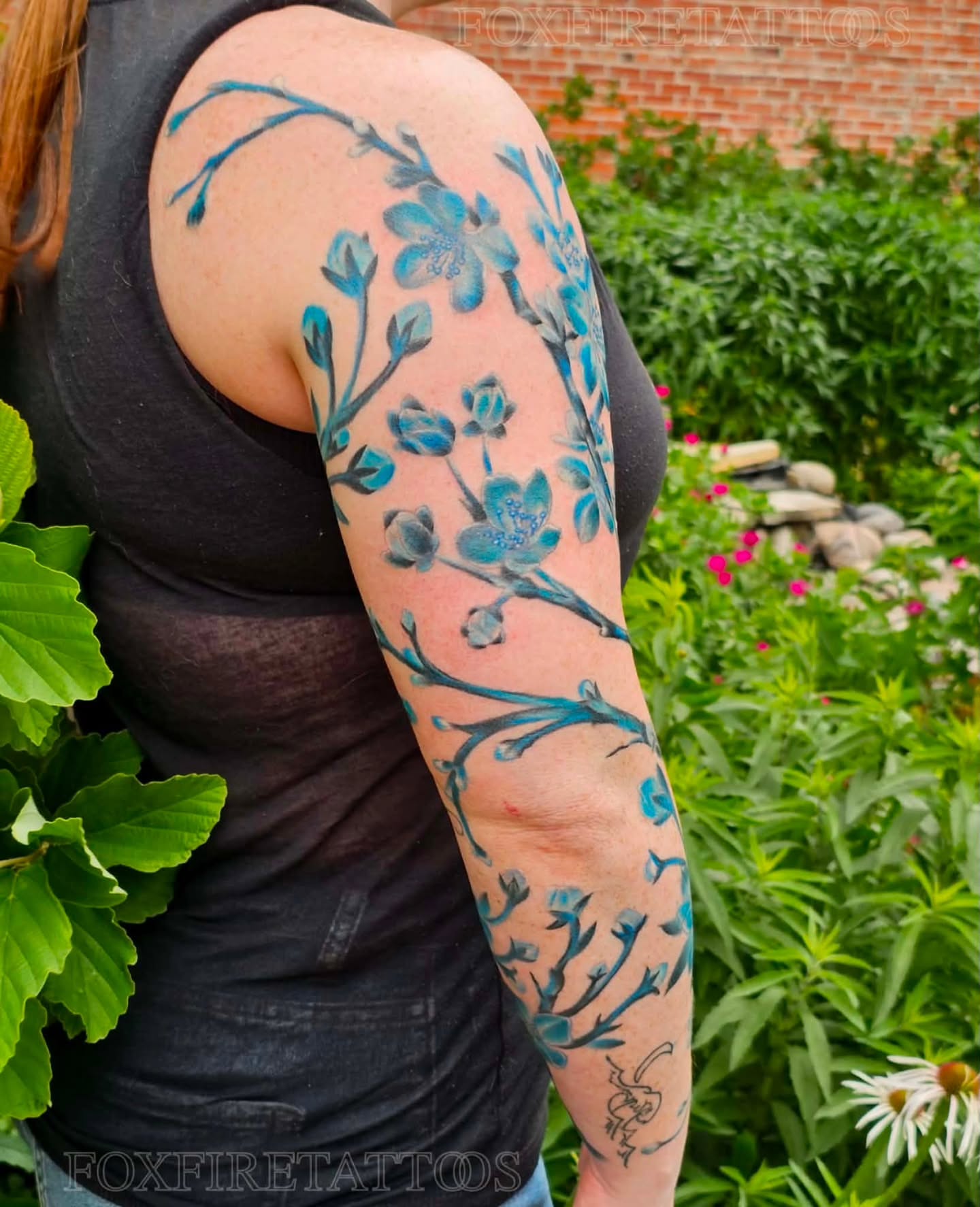 Cherry blossoms watercolor tattoo on the upper arm by Lindsey Chevalier - KCMO TATTOO ARTIST