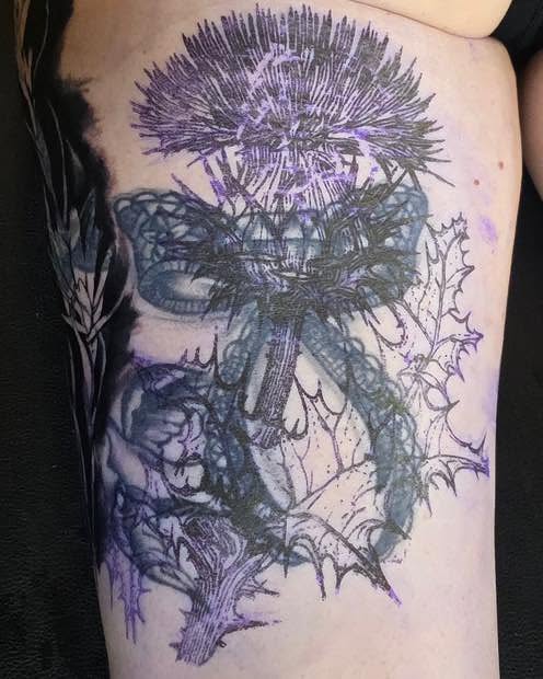 Thistle black and grey tattoo on the thigh by Tank Maass