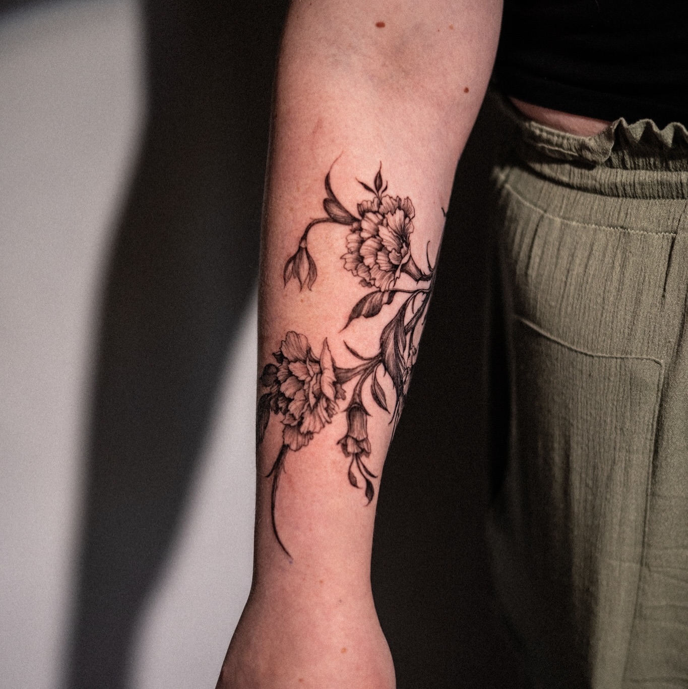 Peony flowers black and grey tattoo on the forearm by Brad Simmons