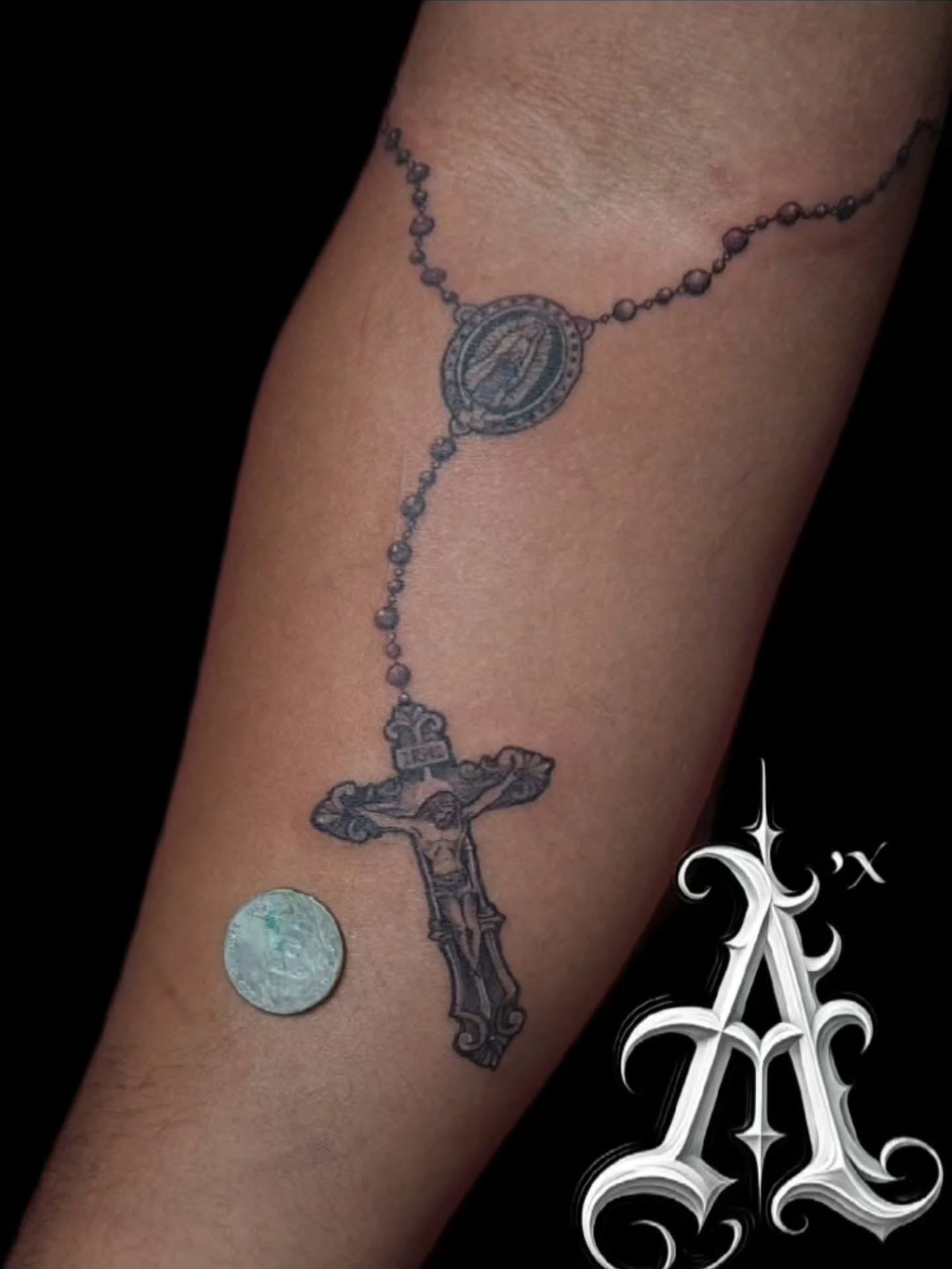 Rosary black and grey tattoo on the forearm by @tattoobytats