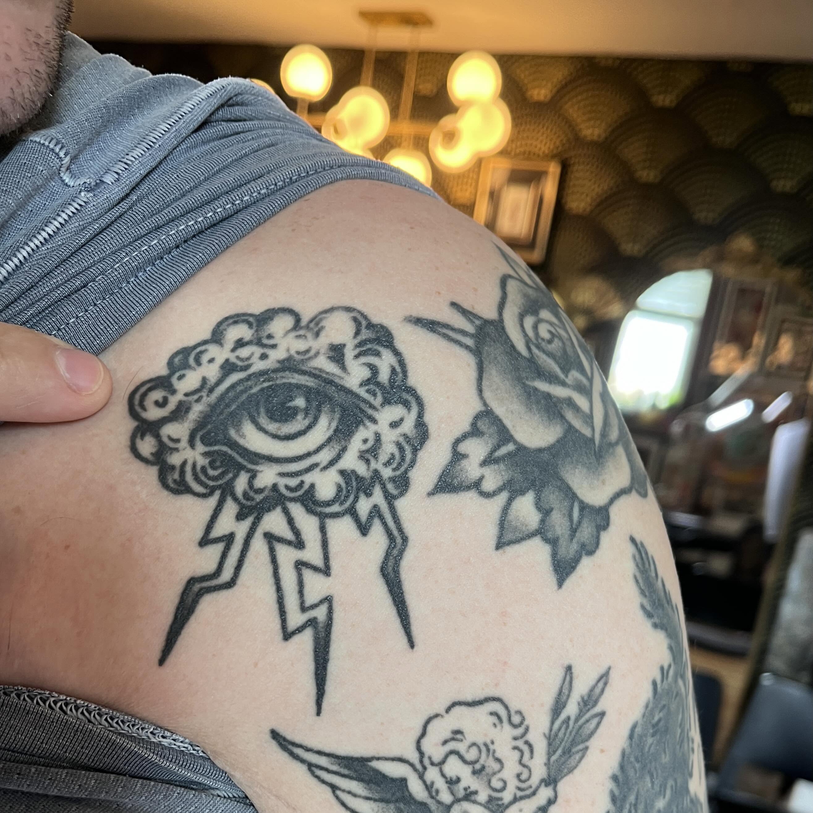 Eye and lightning bolt American traditional tattoo on the shoulder by madelynne (maddie) caldwell tattoos