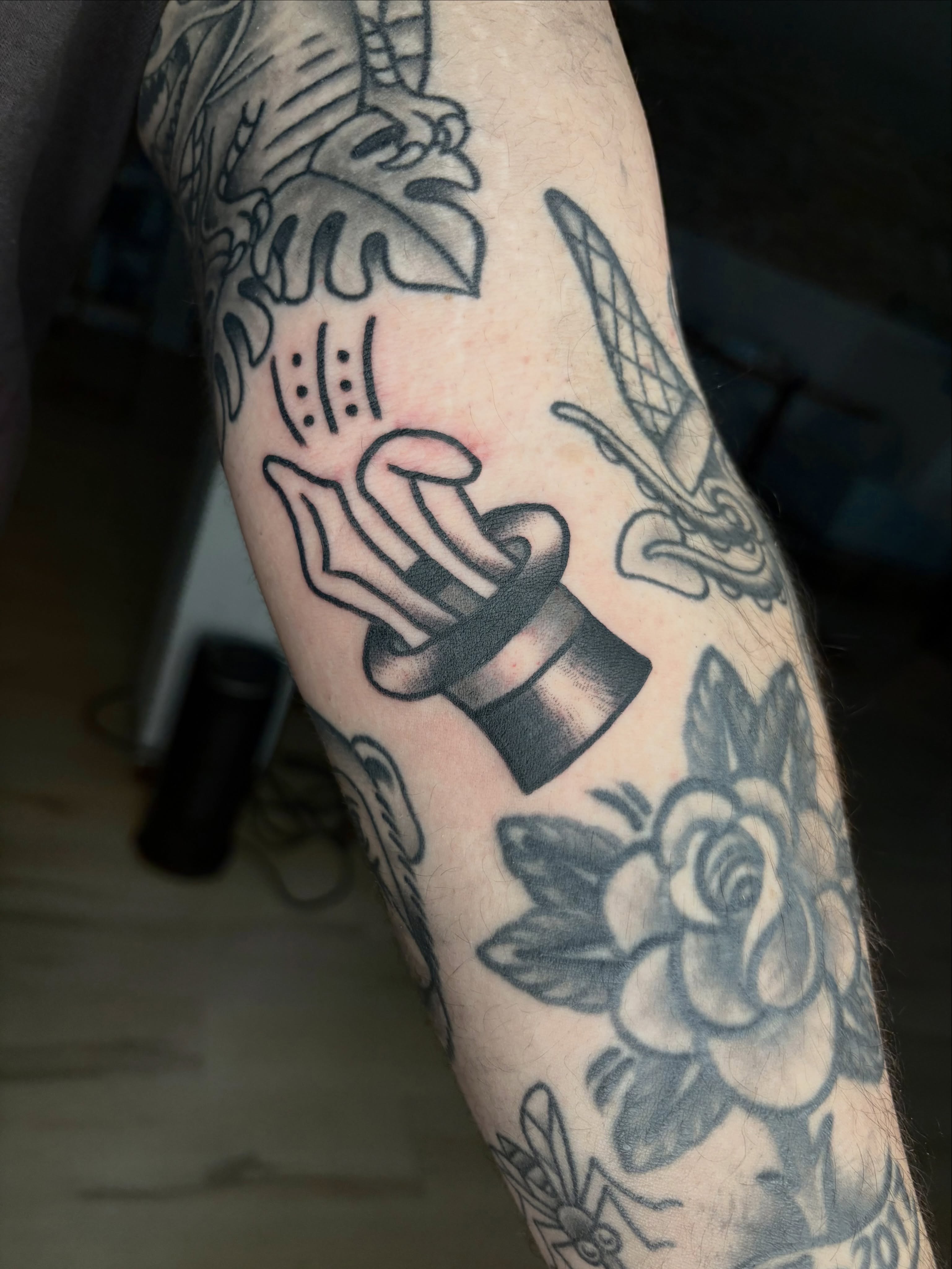 Hat and hand black and grey tattoo on the forearm by Braedon 🎱