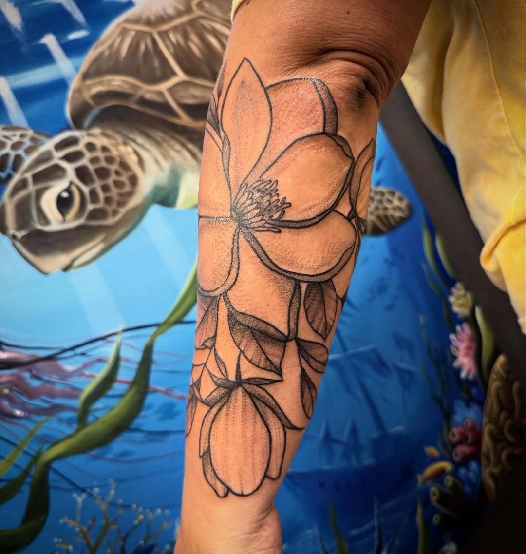 Lotus flower black and grey tattoo on the forearm by Shannon Misitano
