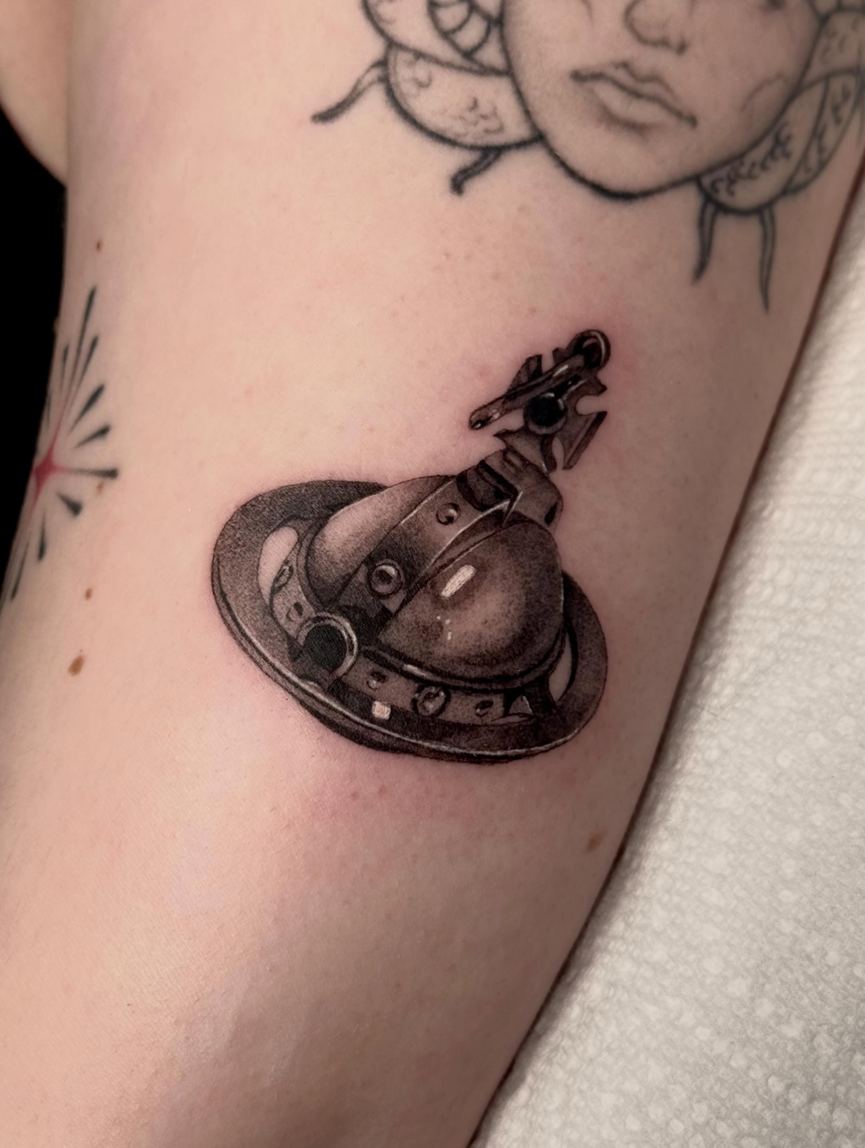 Violin black and grey tattoo on the forearm by Em Krieg
