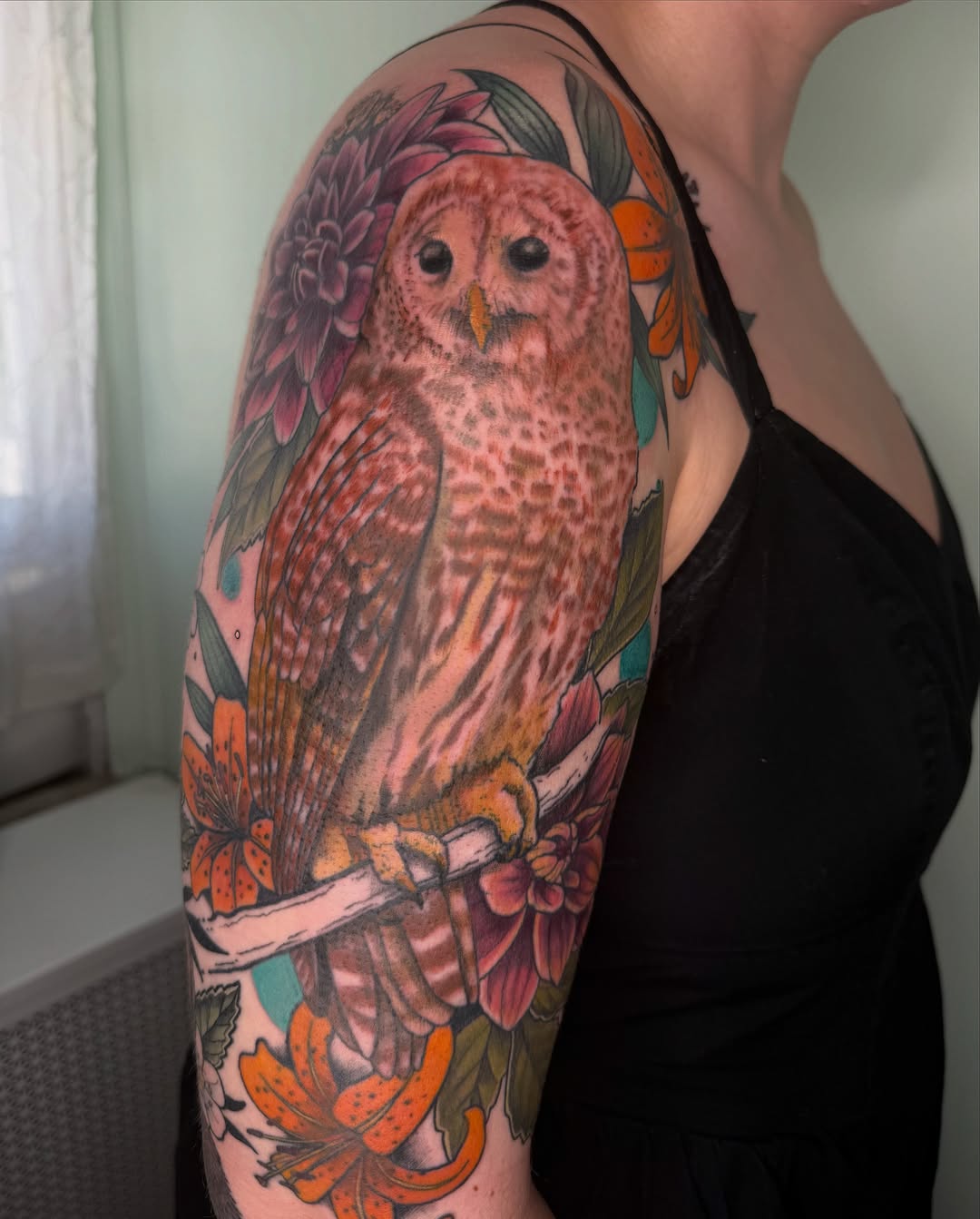 Owl realism tattoo on the upper arm by AJ Jensen