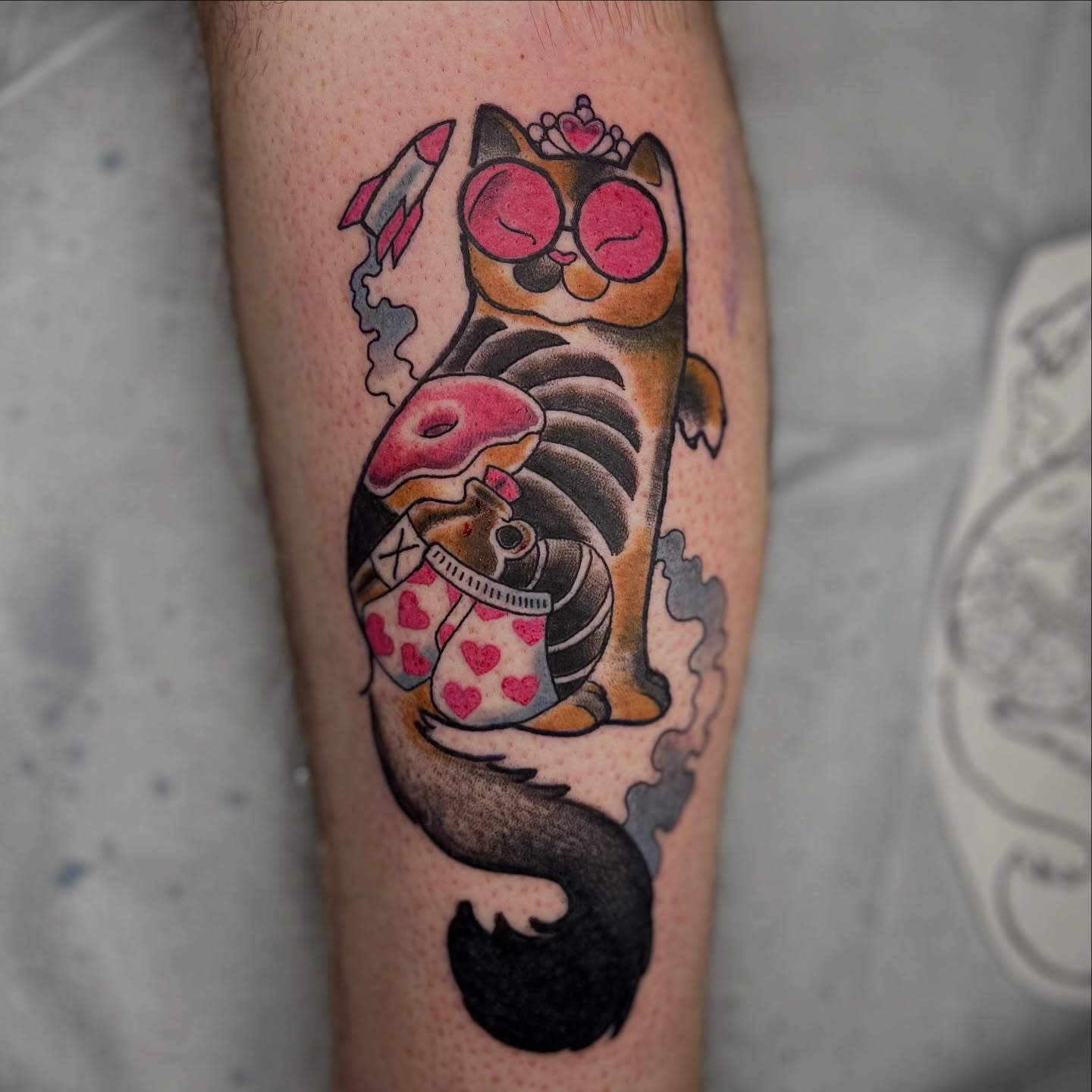 Cat with donut American traditional tattoo on the forearm by Alex Santaloci