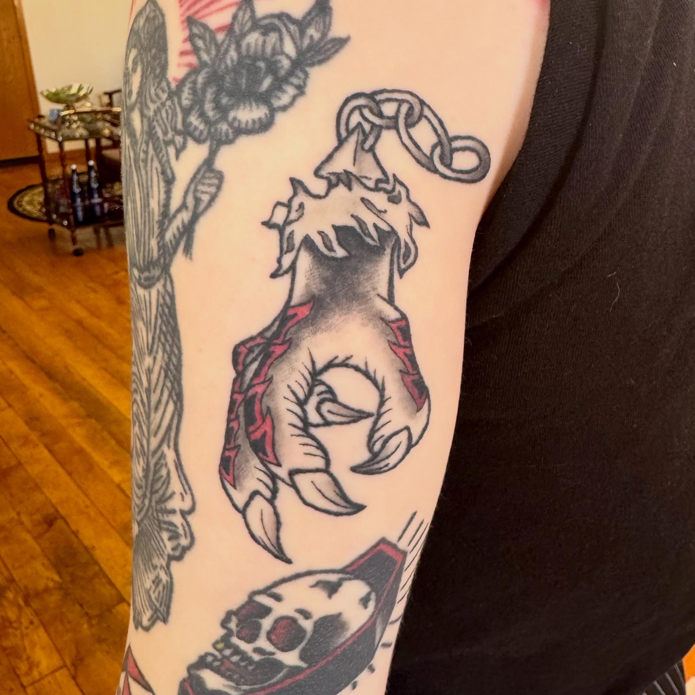 Hand with chain American traditional tattoo on the forearm by Zac Smith-Chevalier
