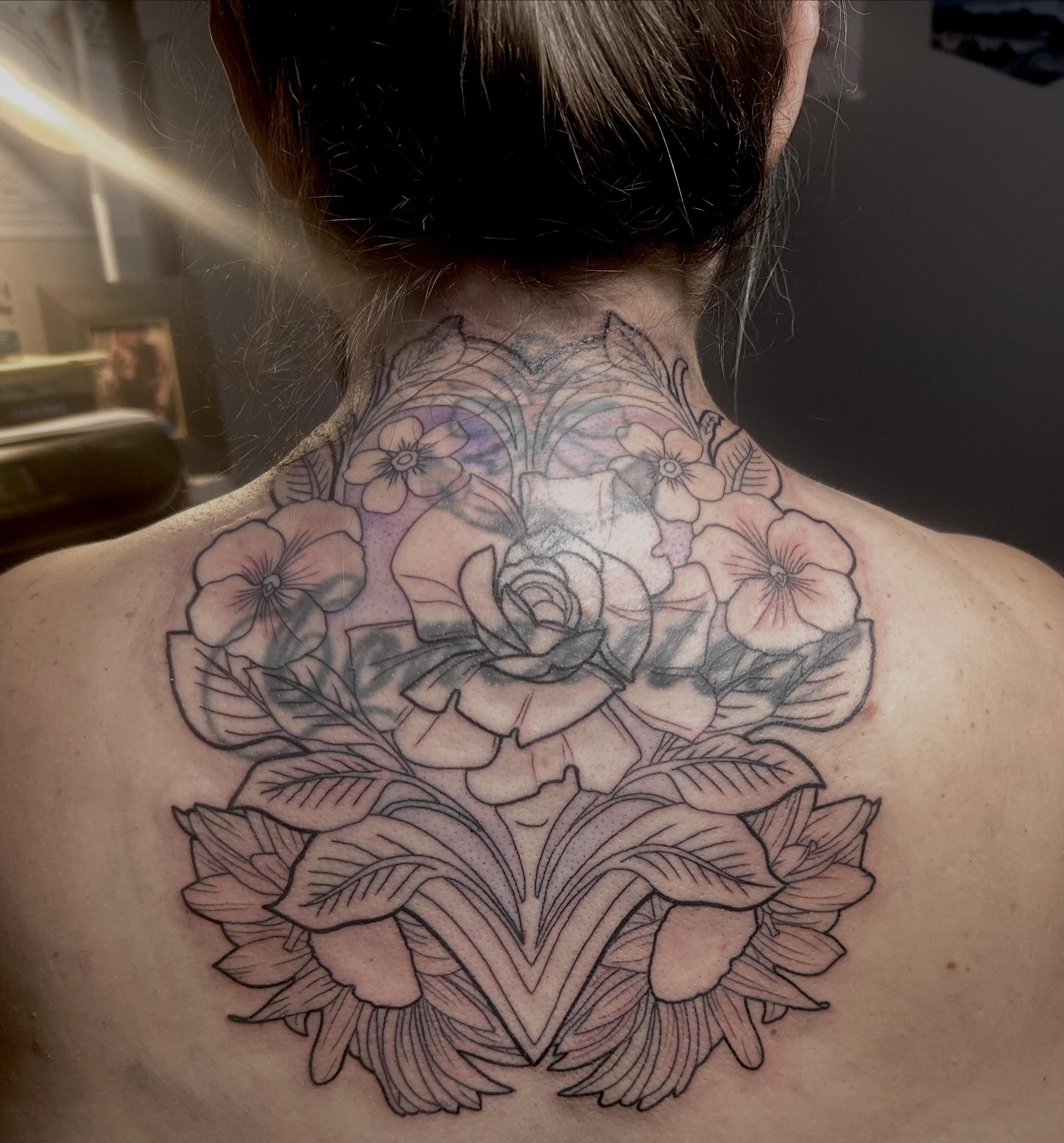 Floral bouquet black and grey tattoo on the back by Jamie Winn