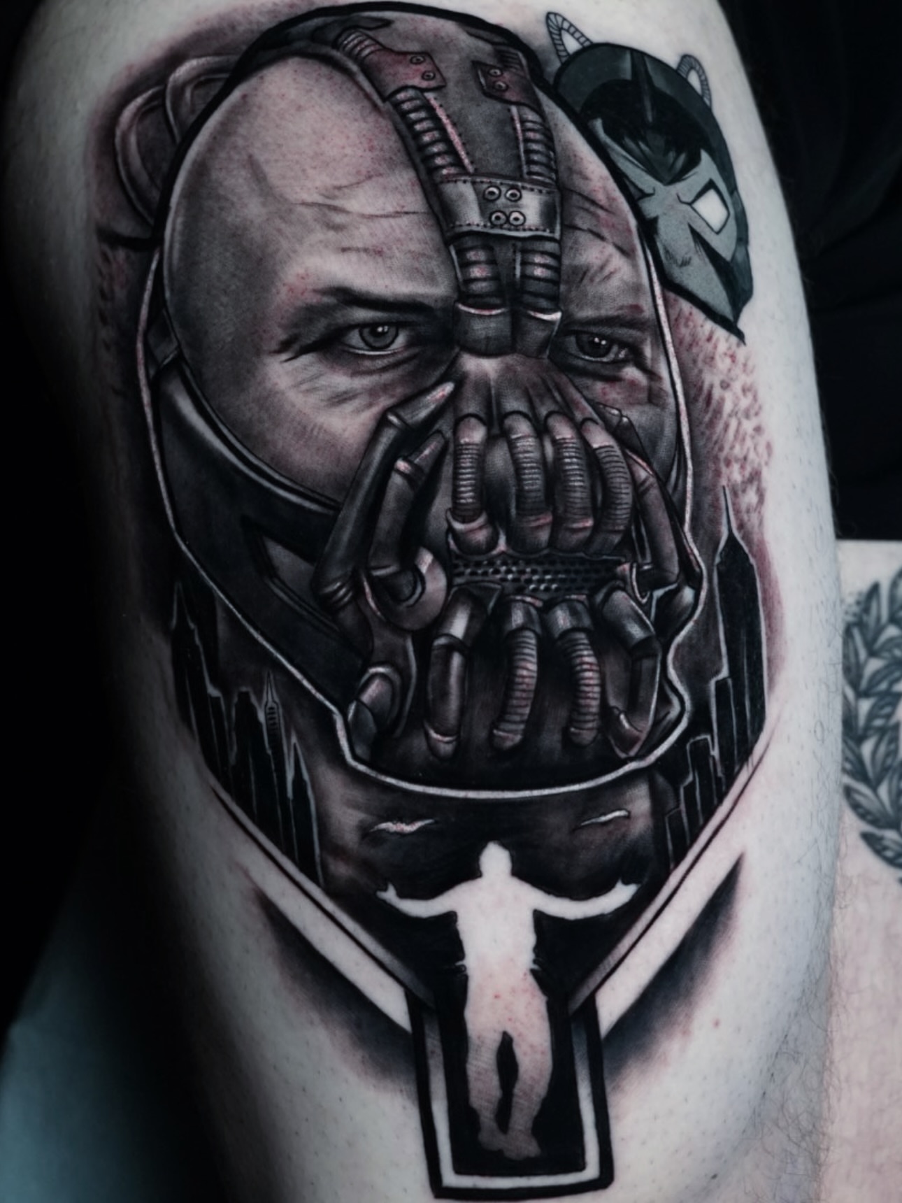 Bane mask dark realism tattoo on the thigh by Jaxx Kesler