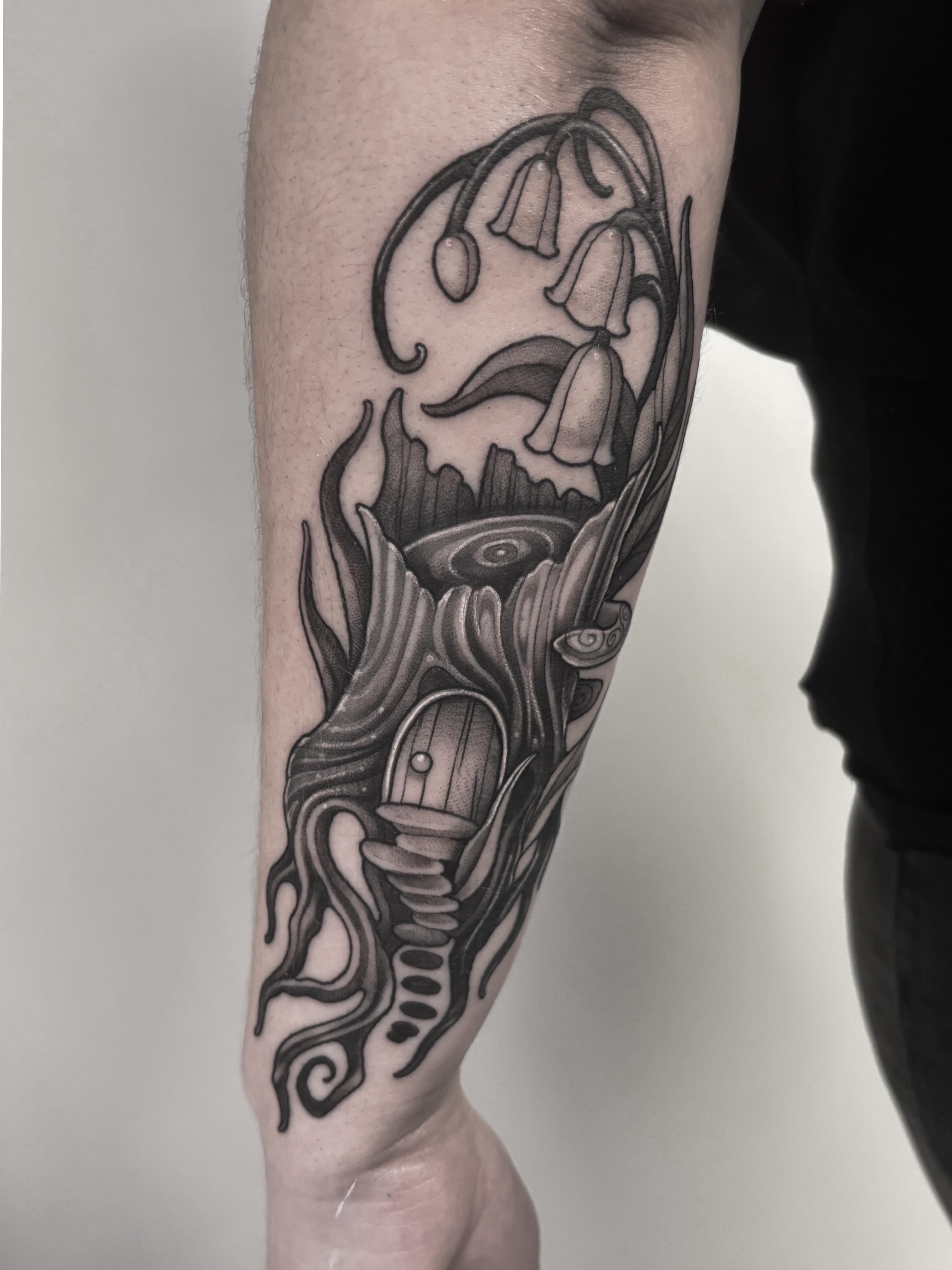 Lily of the valley and mushroom realism tattoo on the forearm by Fairy Gremlin