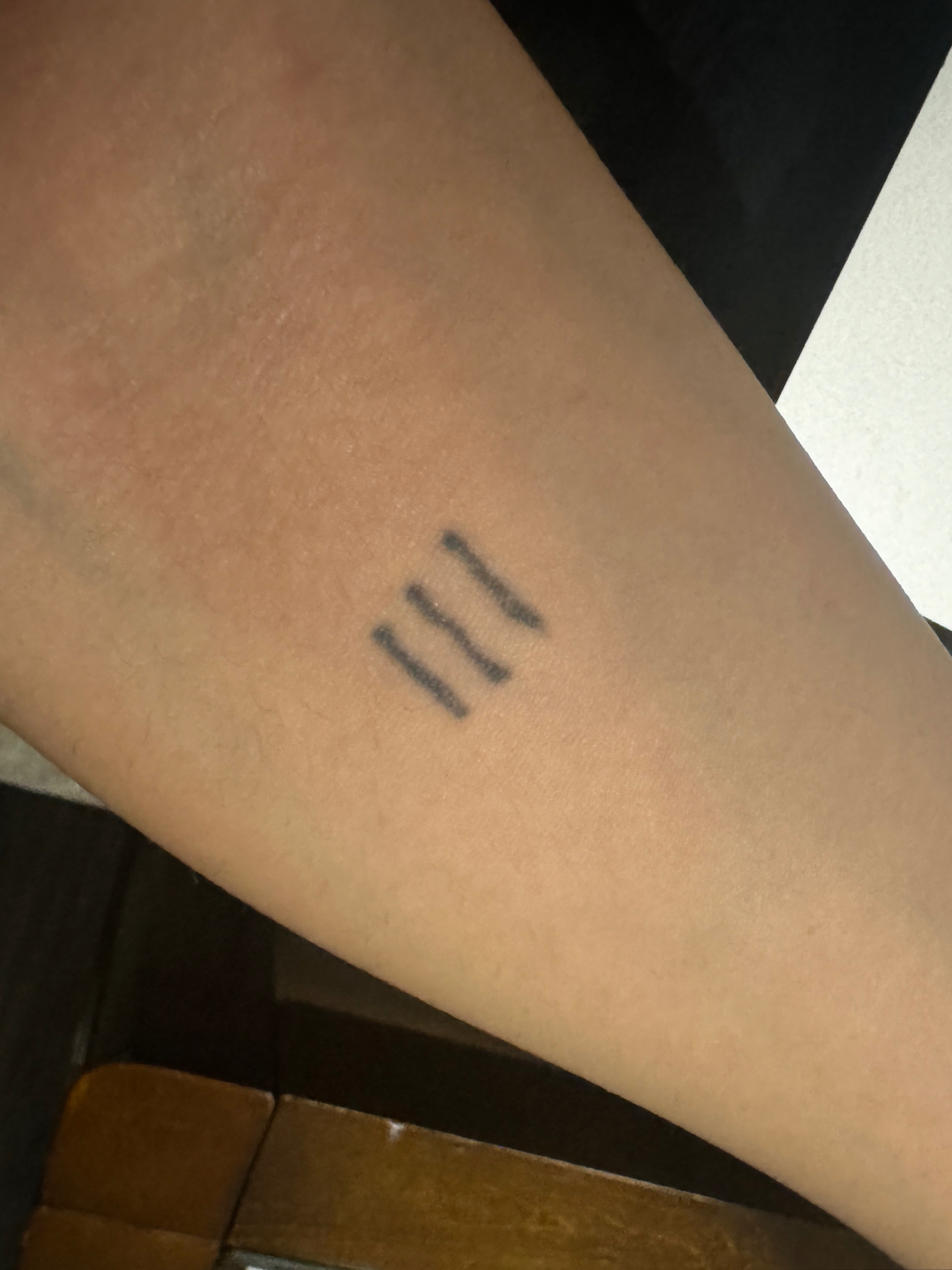 Roman numerals black and grey tattoo on the forearm by cait
