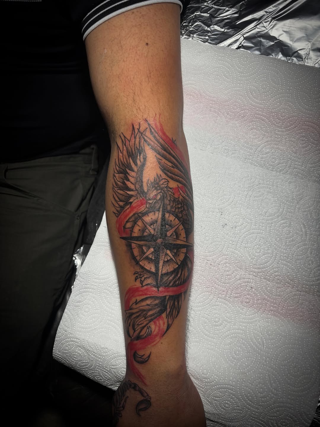 Phoenix and compass American traditional tattoo on the forearm by Jonny Vicious