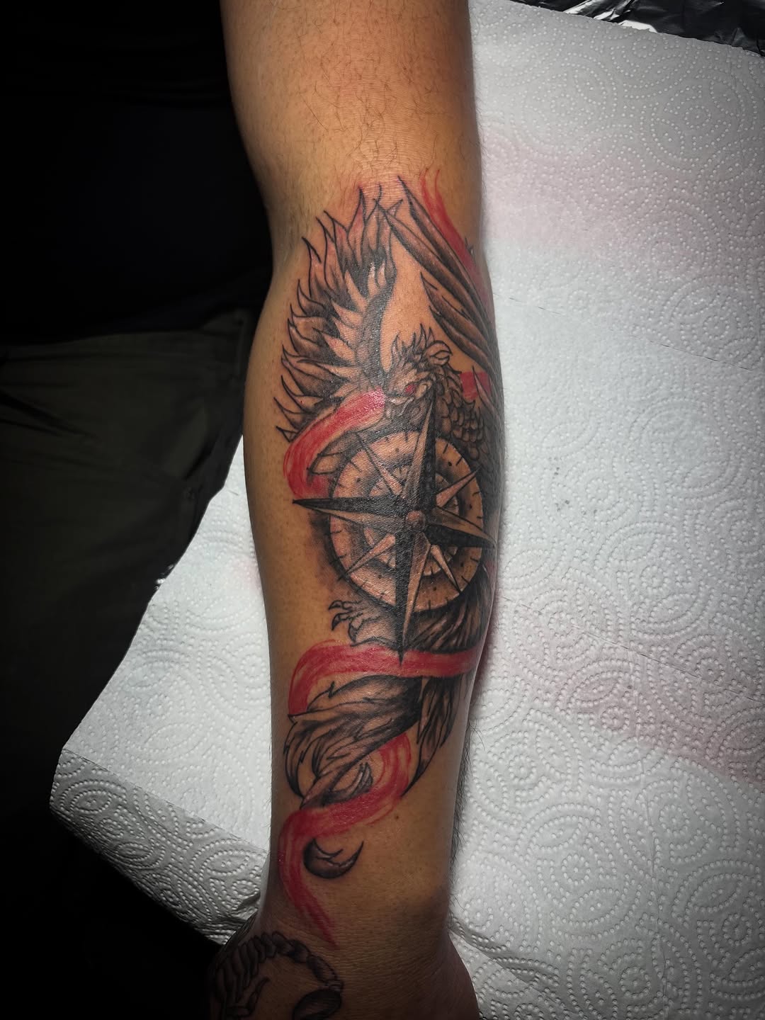 Phoenix and compass American traditional tattoo on the forearm by Jonny Vicious