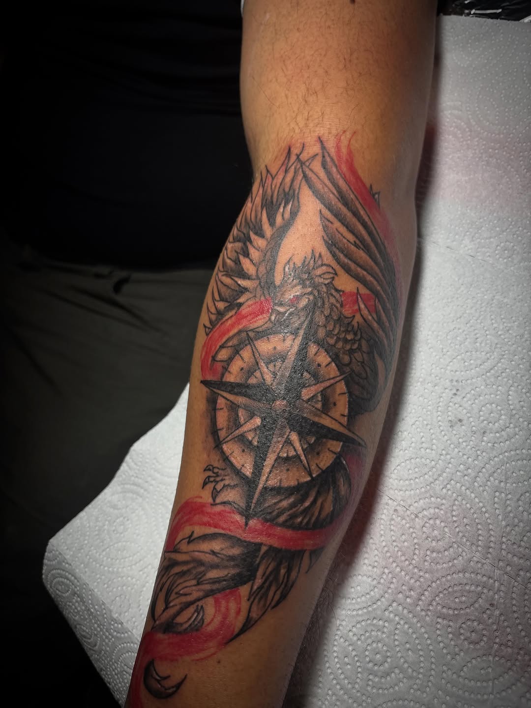 Phoenix and compass tribal tattoo on the forearm by Jonny Vicious