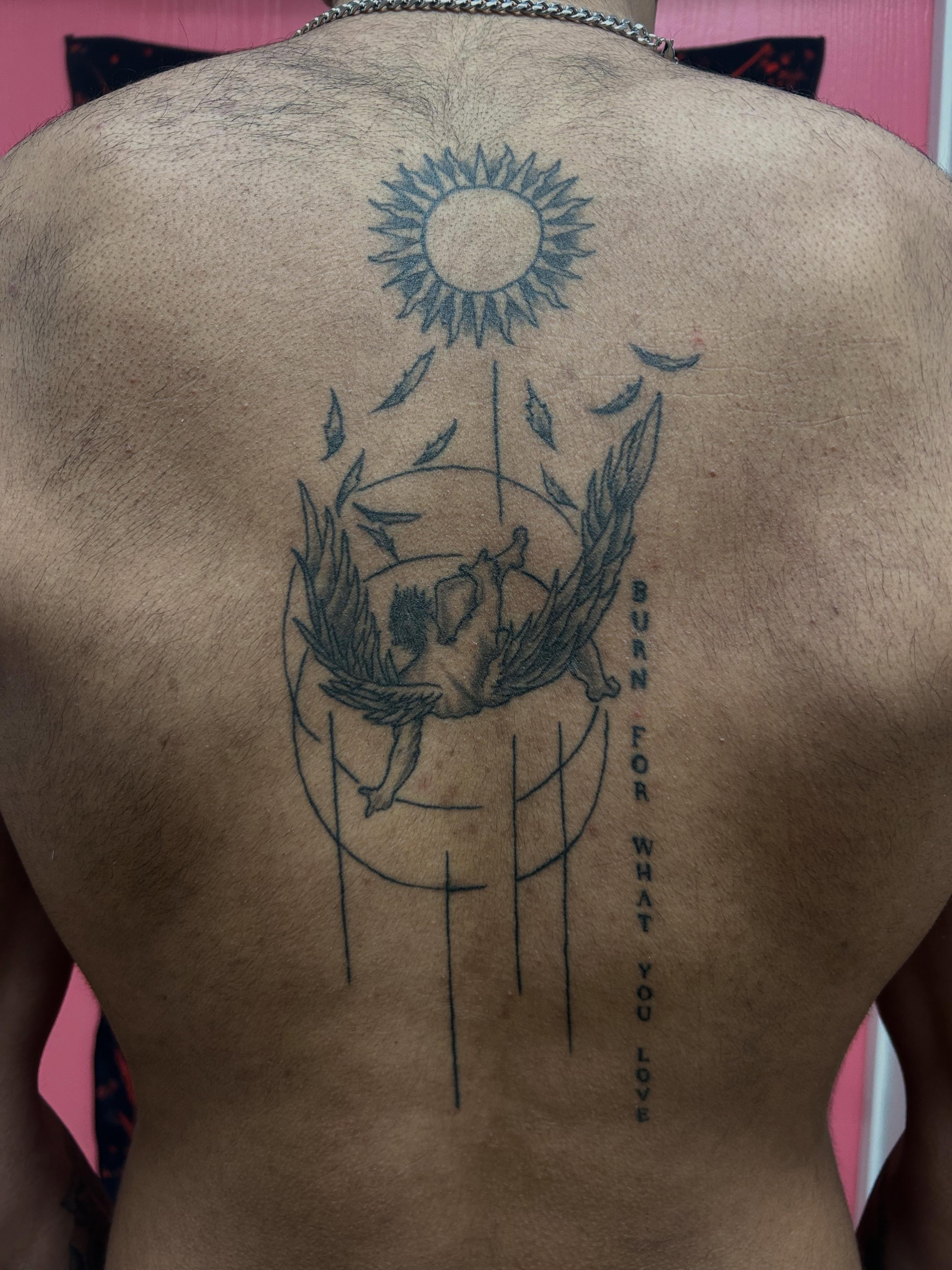 Sunflower and skull black and grey tattoo on the back by Stogie Tony